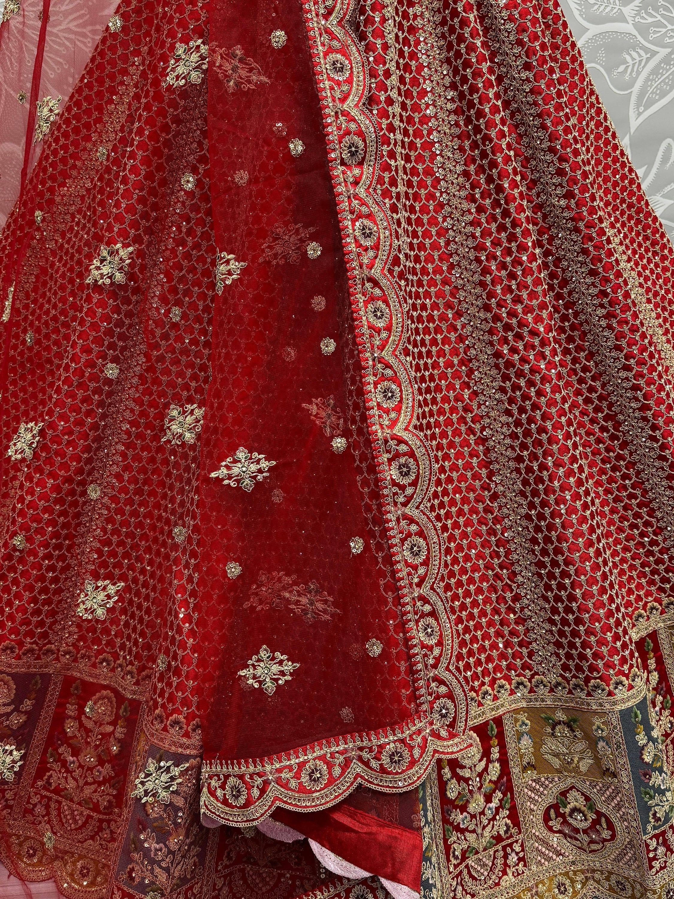 Red designer lehenga choli with intricate gold embroidery and sequin work, perfect for weddings and festivals