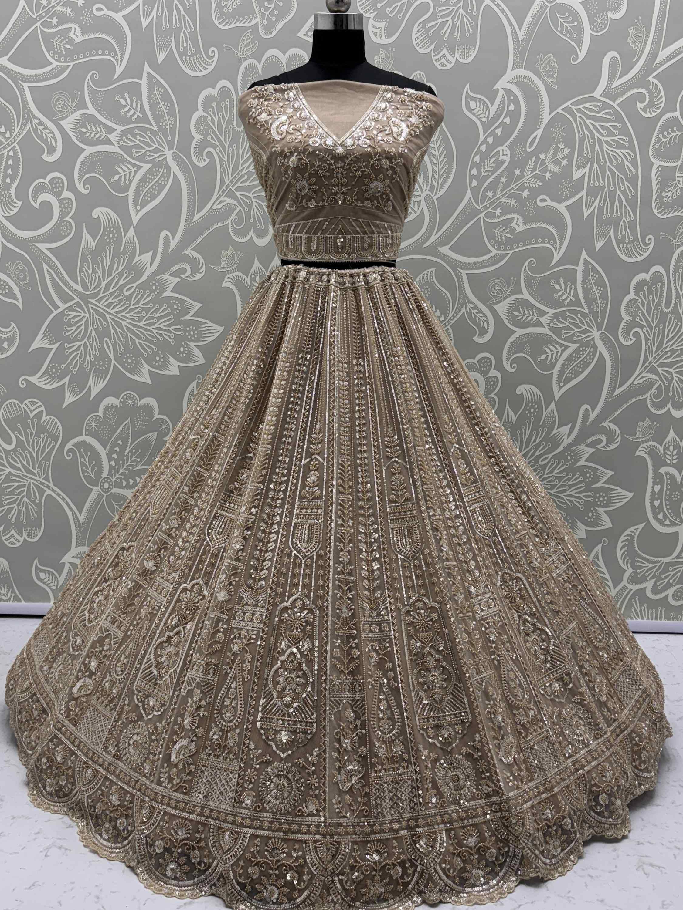 Beige designer lehenga choli with heavy embroidery and sequins, perfect for Indian weddings and festive occasions.