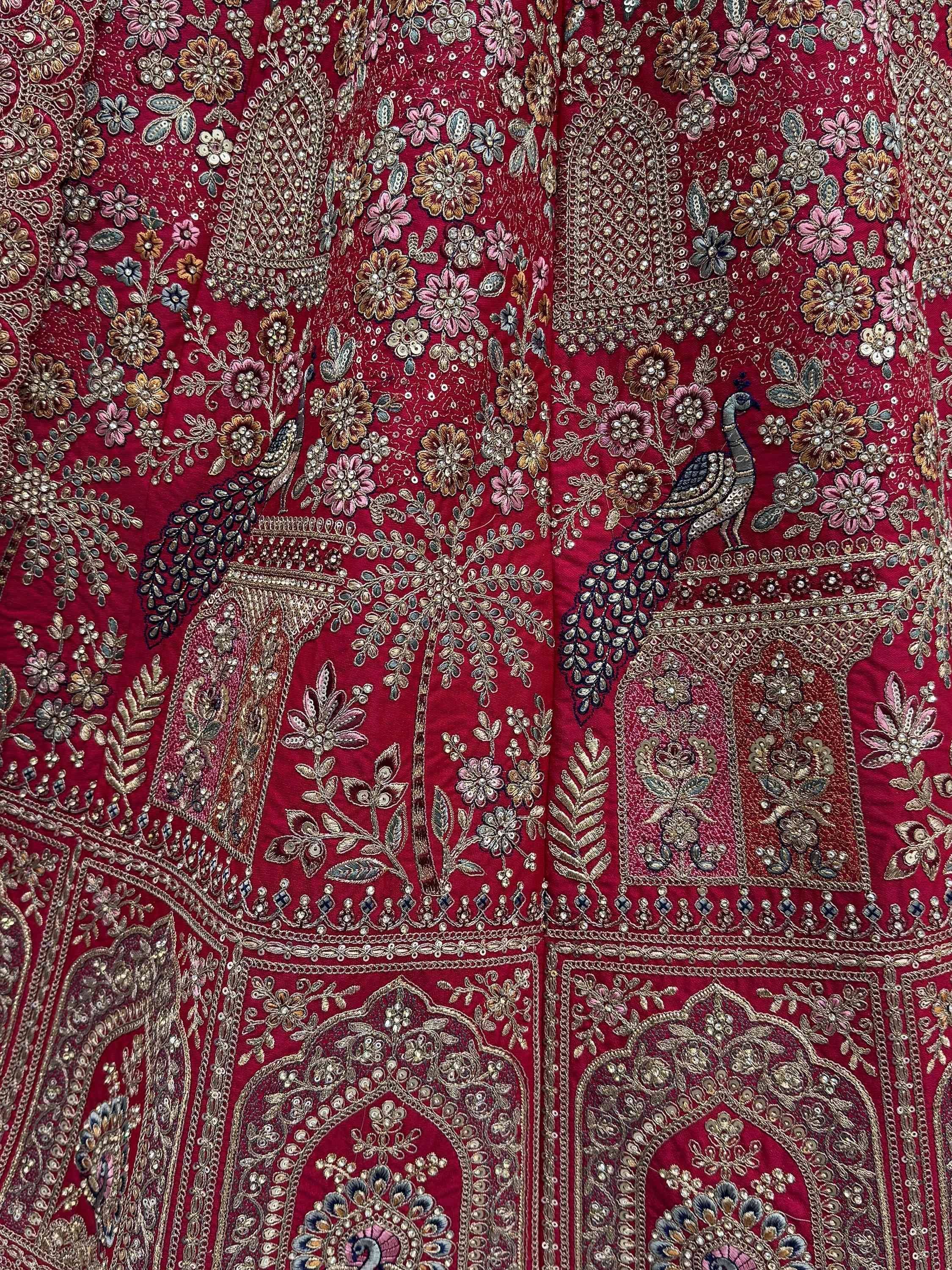 Richly embroidered maroon lehenga with peacock and floral motifs, perfect for Indian ethnic wear.