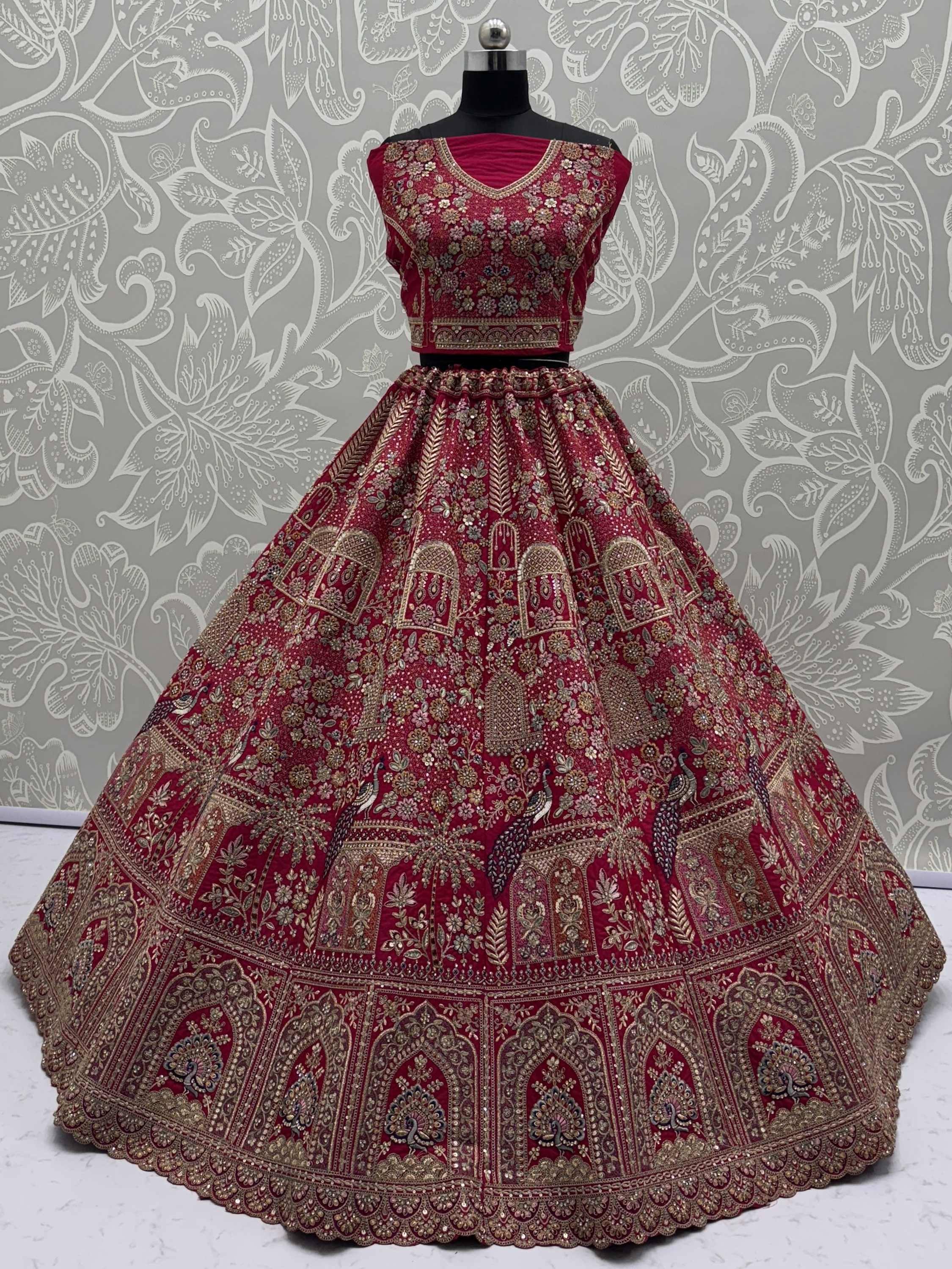Maroon designer lehenga choli with gold embroidery and peacock motifs, perfect for Indian weddings and festive occasions.