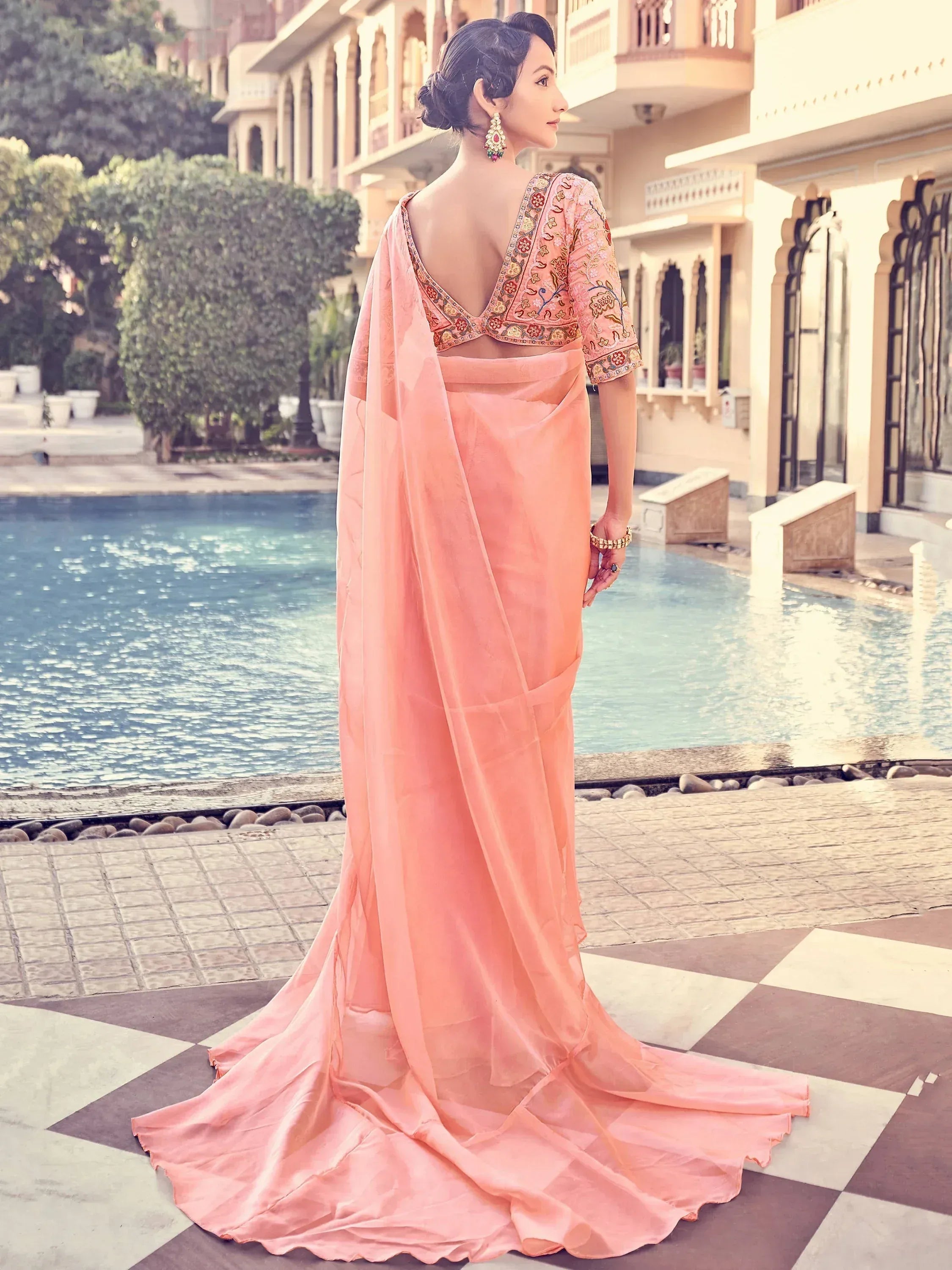 Elegant peach ethnic gown with embroidered blouse, perfect for Indian weddings or festive occasions.