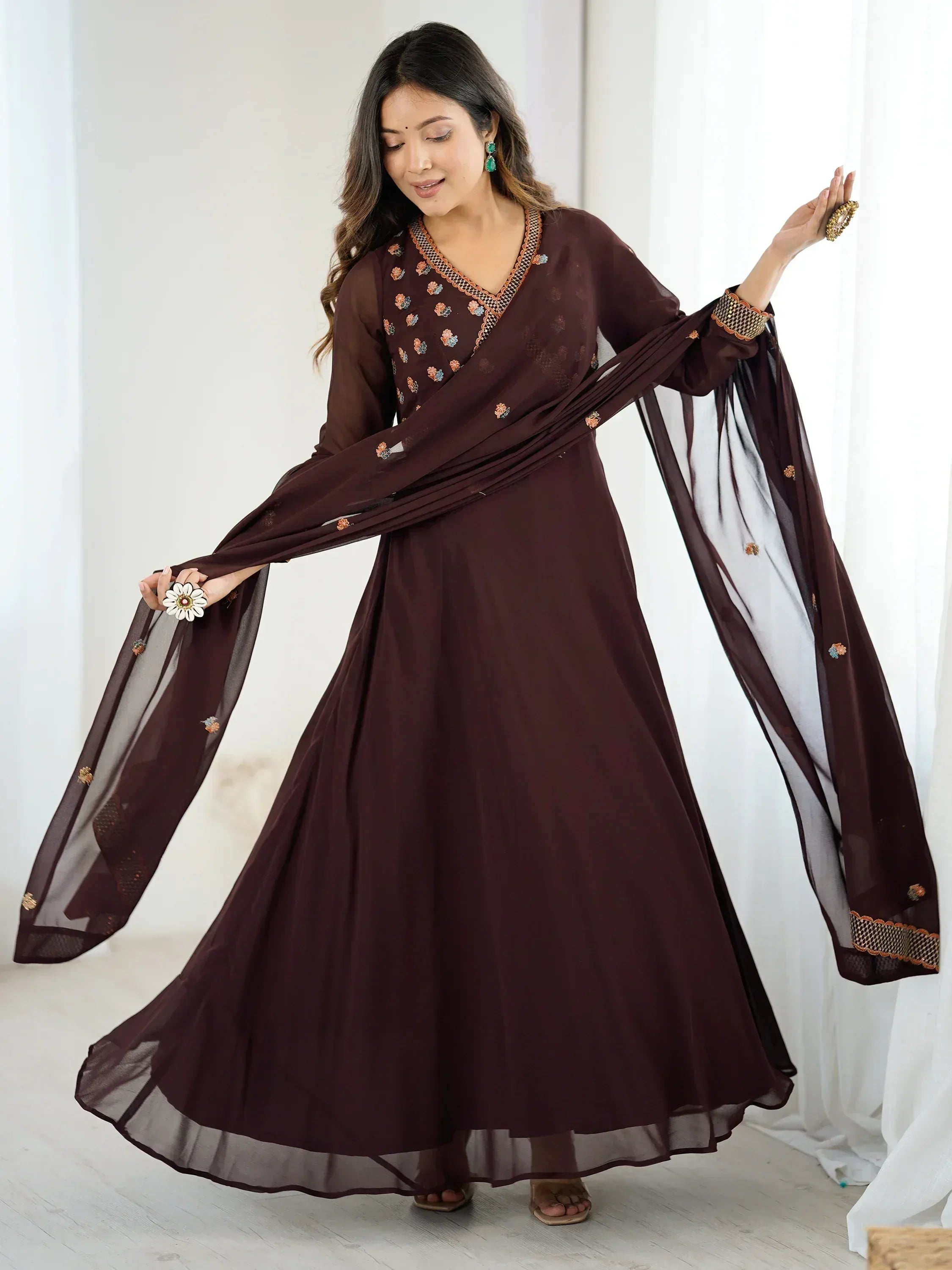 Elegant maroon ethnic gown with floral embroidery and sheer dupatta, perfect for Indian occasions