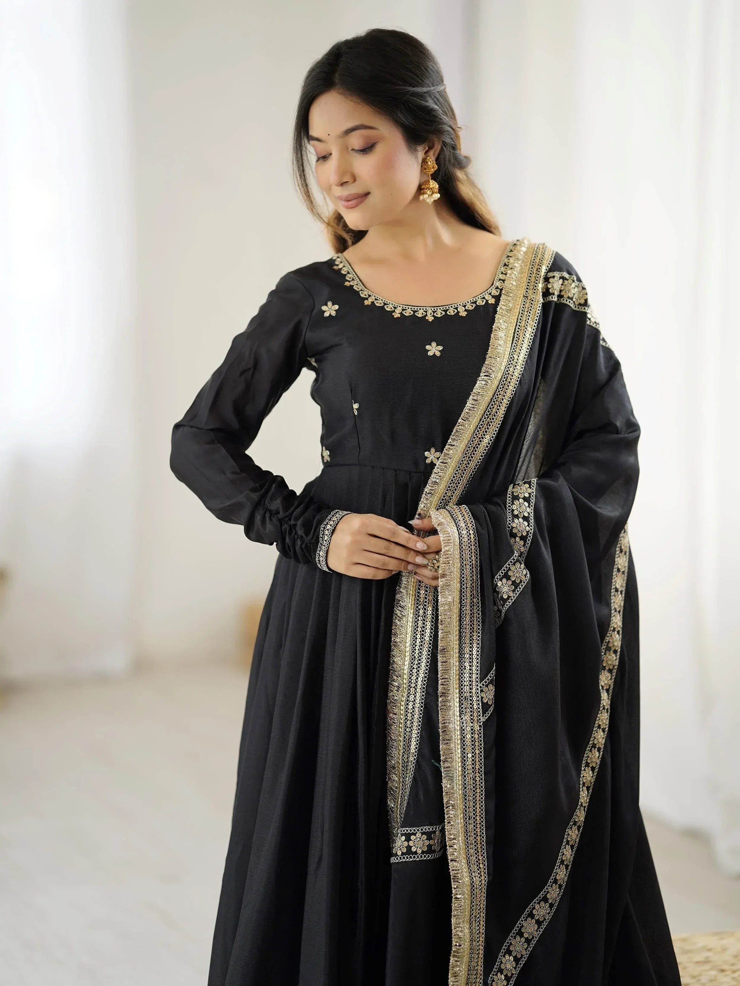 Black ethnic gown with gold embroidery, perfect for Indian festive wear and designer occasions.