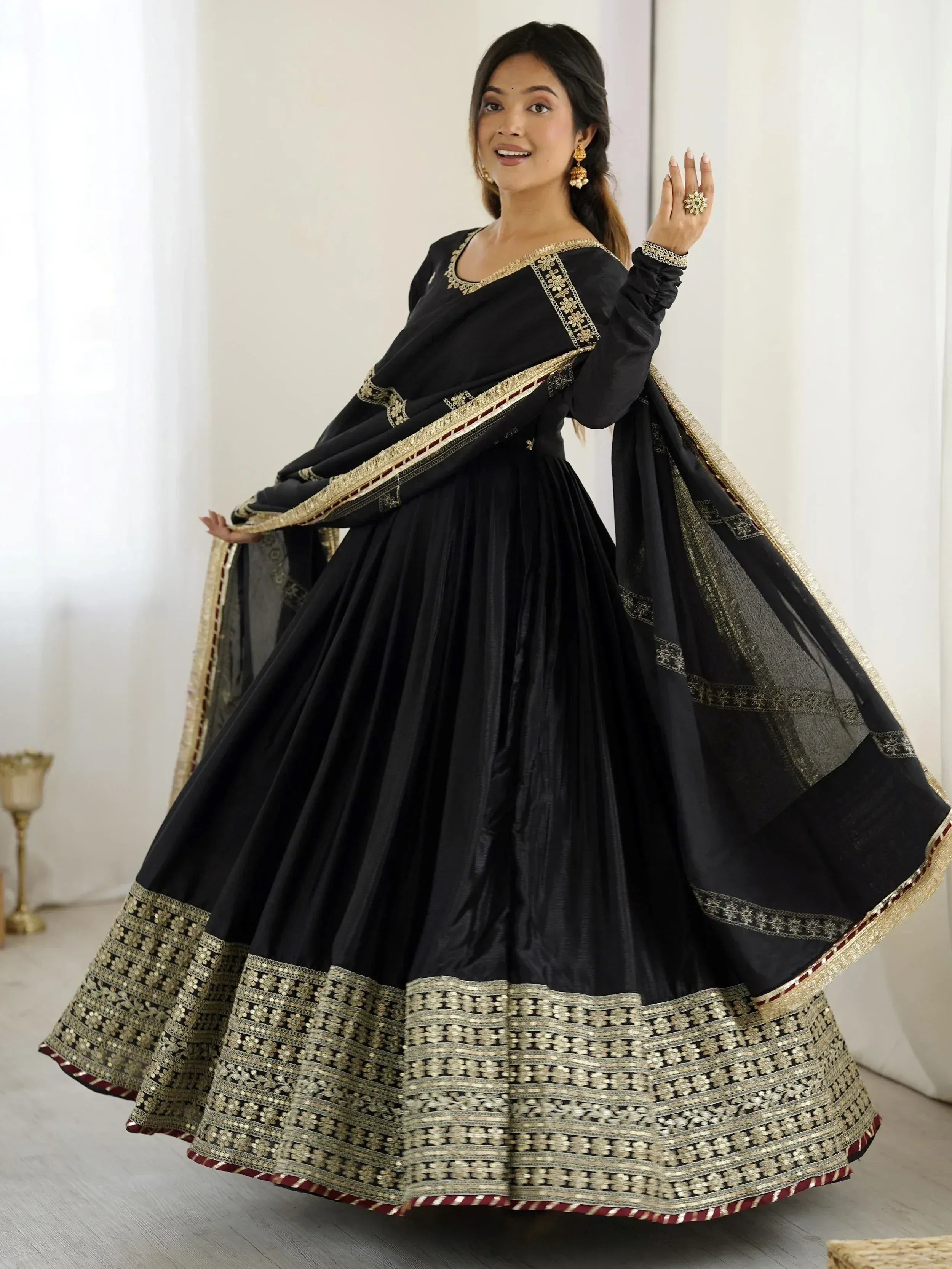 Black ethnic lehenga choli with gold embroidery and mirror work, perfect for weddings and festivals