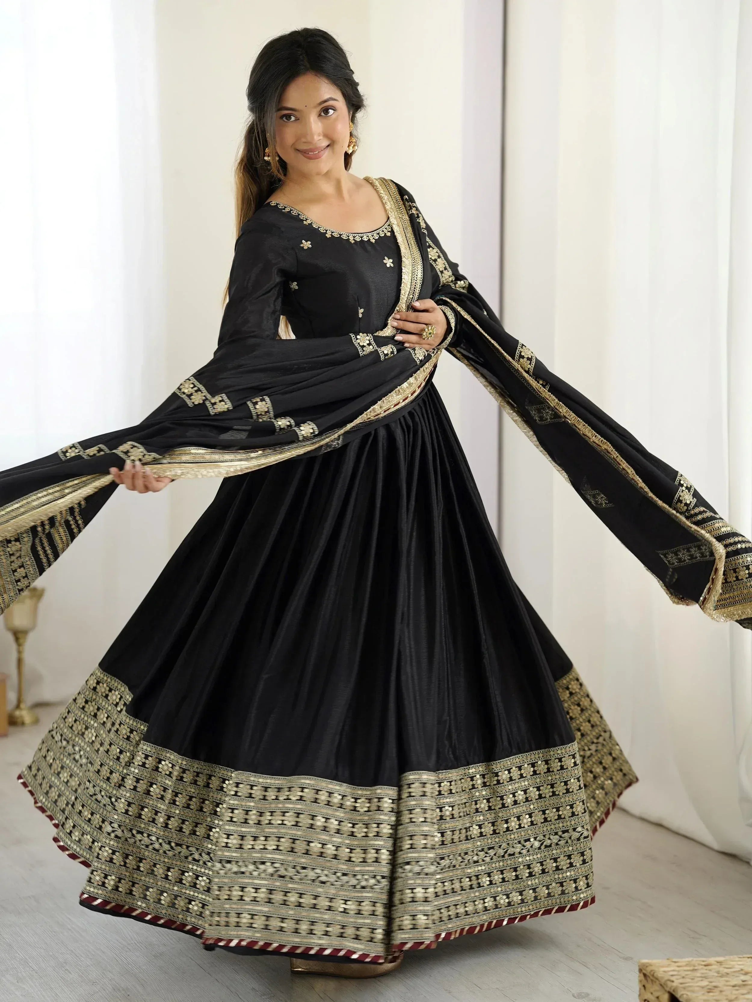 Black ethnic anarkali suit with gold embroidery and dupatta, perfect for festive occasions
