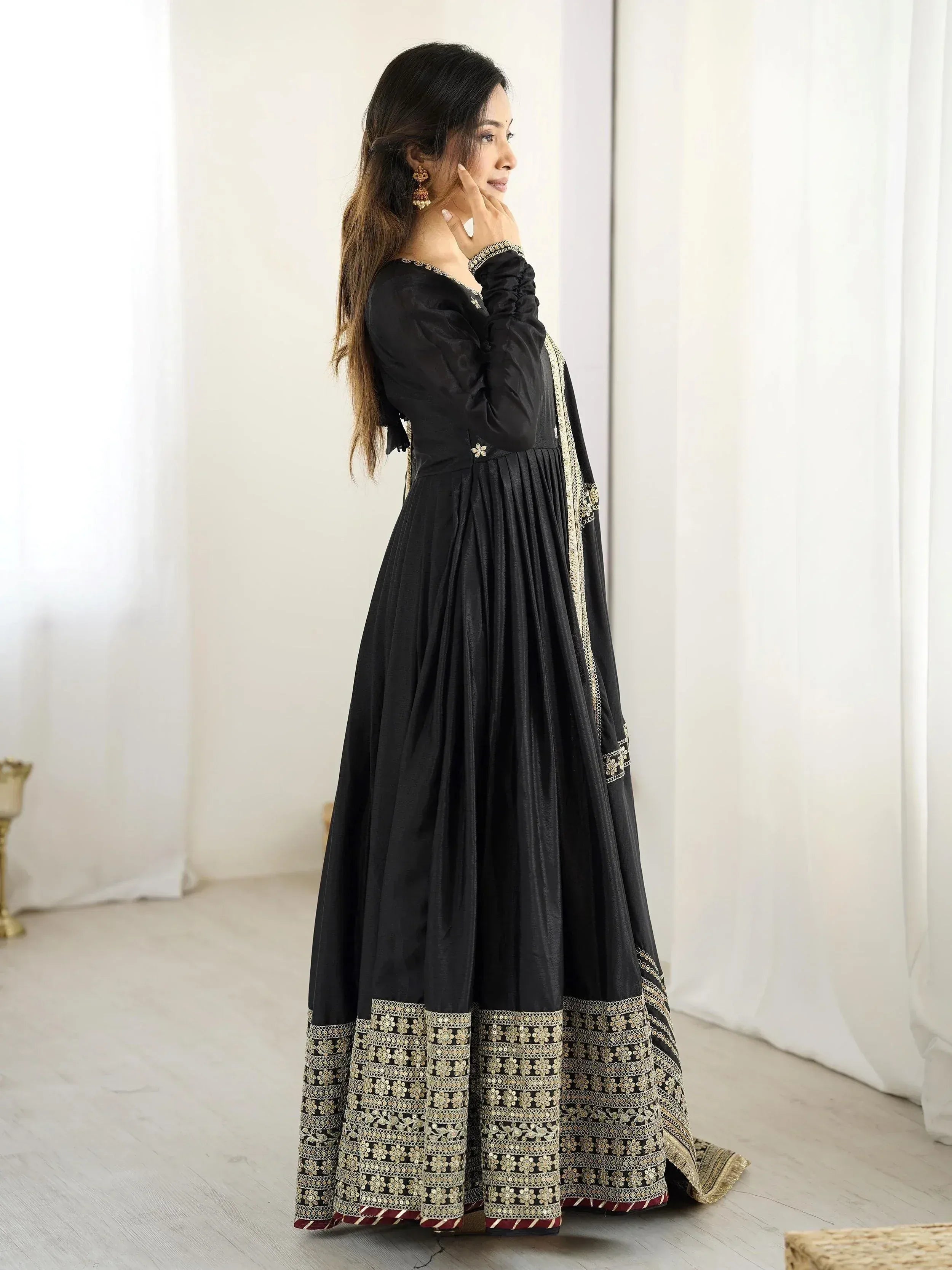 Black ethnic gown with gold embroidery, perfect for Indian festive occasions and weddings.
