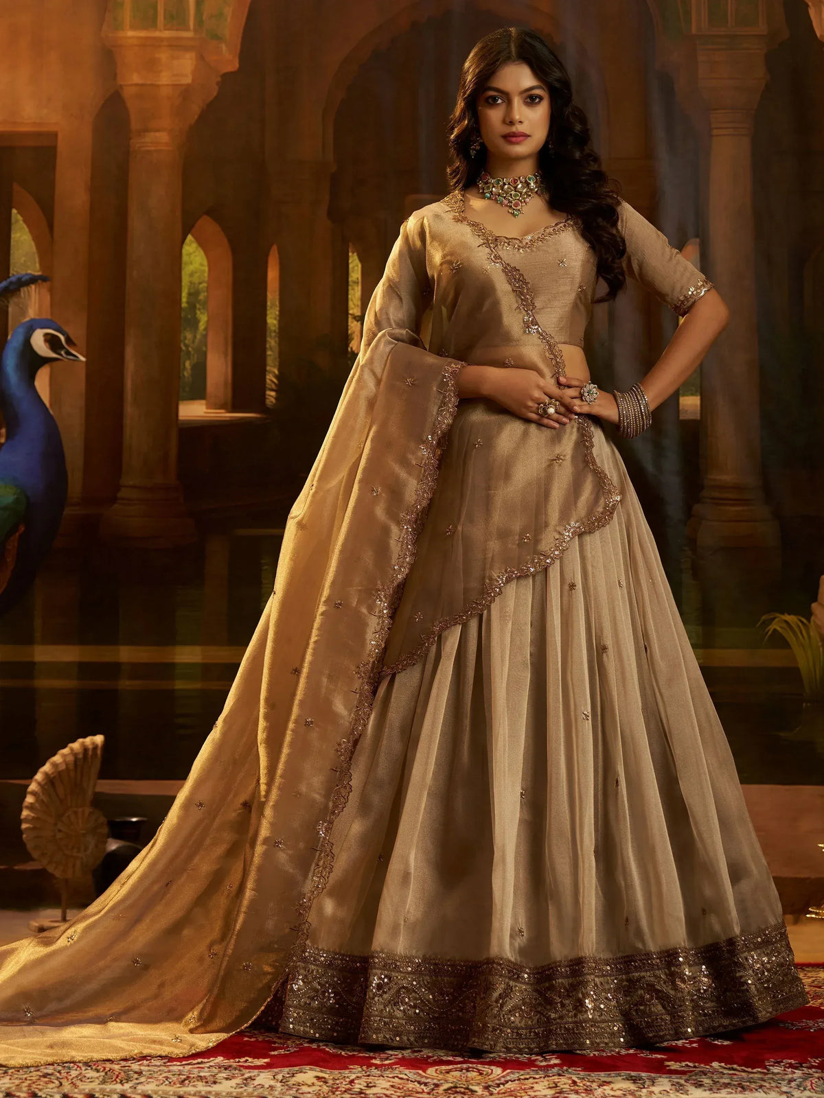 Elegant beige designer lehenga choli with gold embroidery, perfect for Indian ethnic wear occasions.