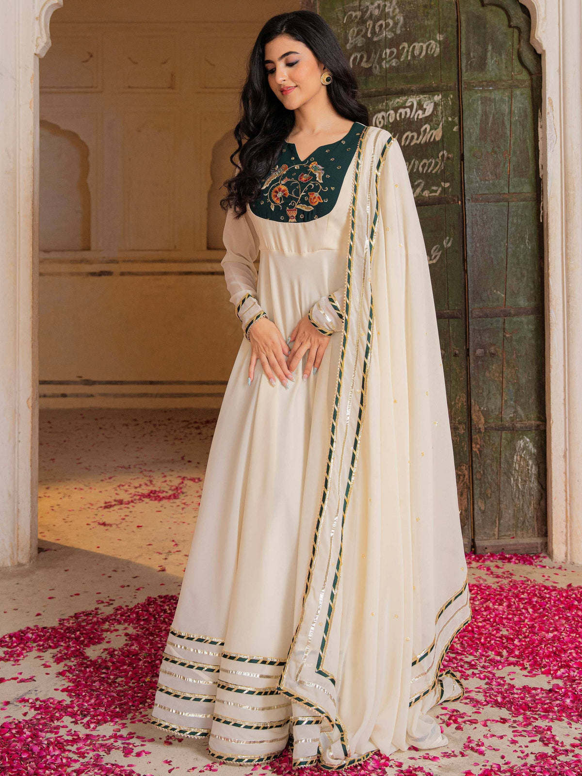 Cream and green embroidered Anarkali suit with floral detailing, perfect for Indian ethnic wear occasions.