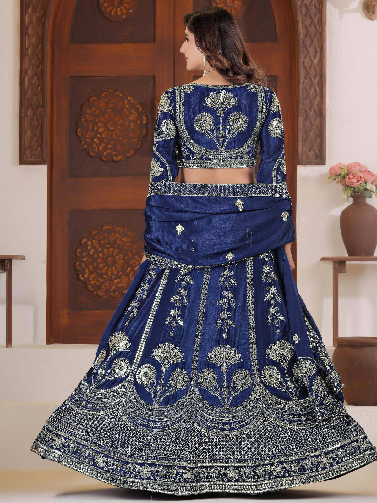 Royal blue embroidered lehenga choli with gold floral work, perfect for Indian weddings and festive occasions.