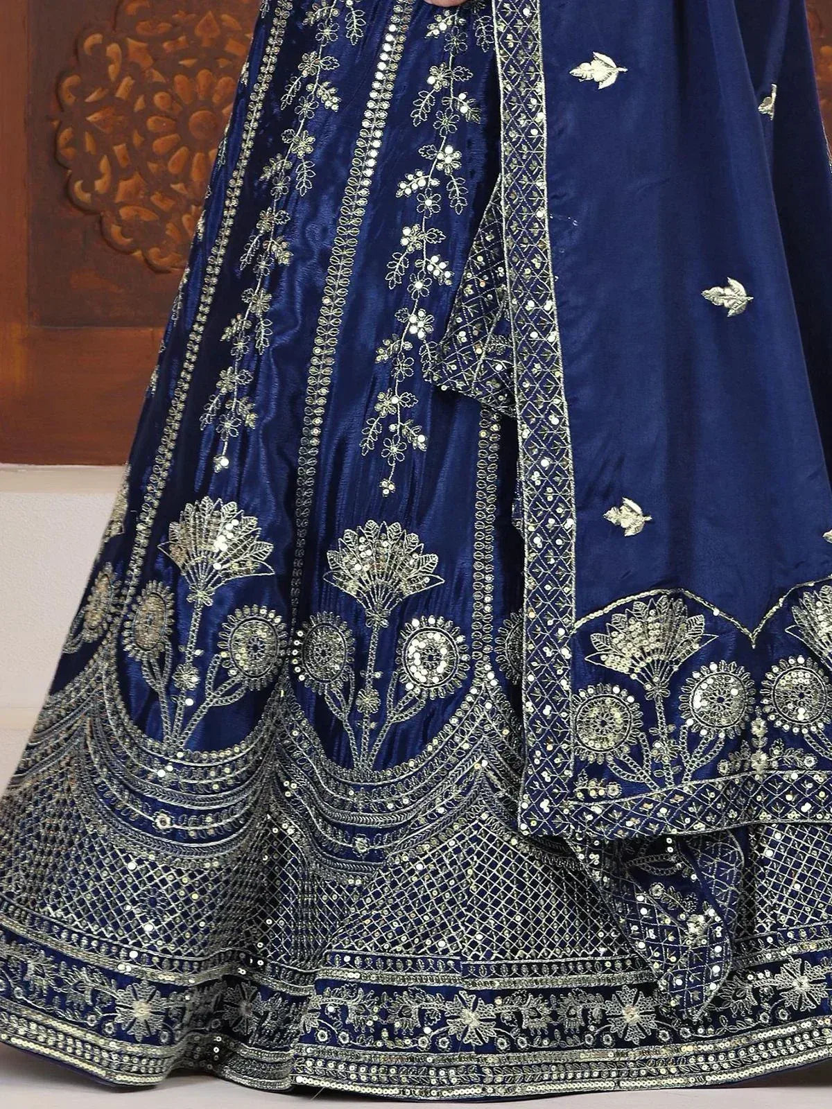 Royal blue lehenga choli with intricate silver embroidery and mirror work, perfect for Indian weddings.
