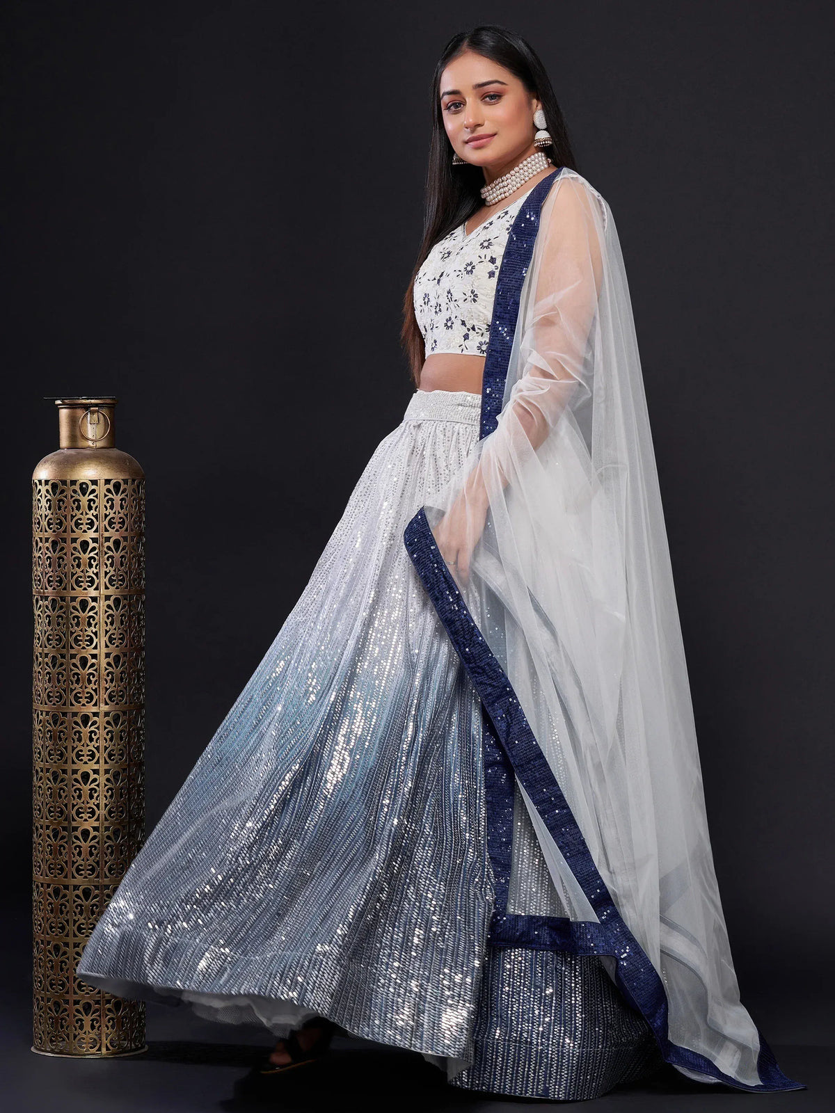 Elegant white and blue sequined lehenga choli with sheer dupatta, perfect for Indian ethnic wear