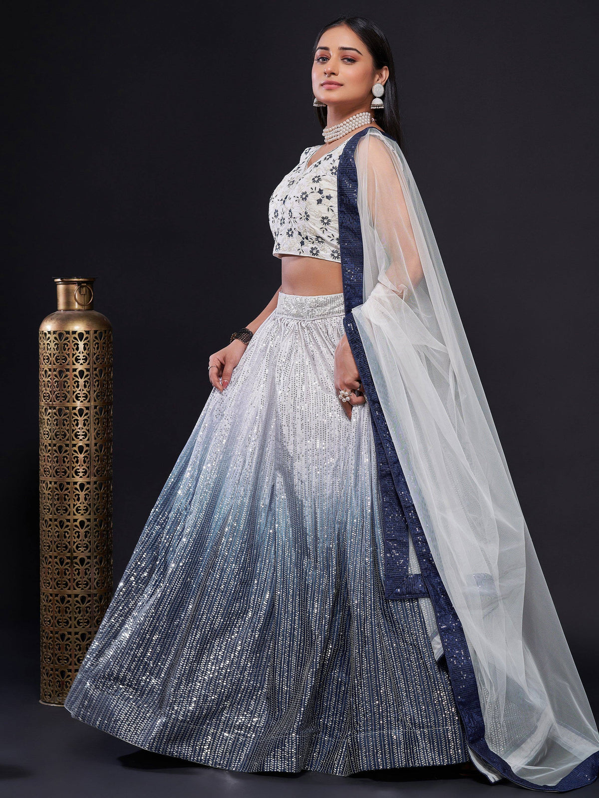 Elegant white and navy blue sequin lehenga choli with sheer dupatta, perfect for Indian ethnic occasions