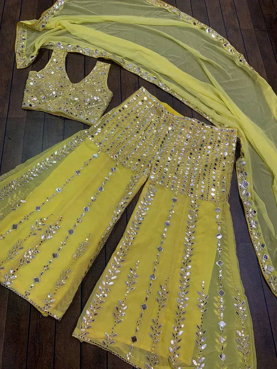 Yellow mirror-work sharara set with embellished top and dupatta, ethnic Indian wear