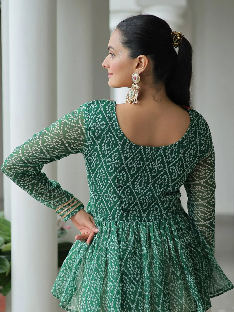 Green printed ethnic gown with back cutout, gold trim, and statement earrings for Indian wear