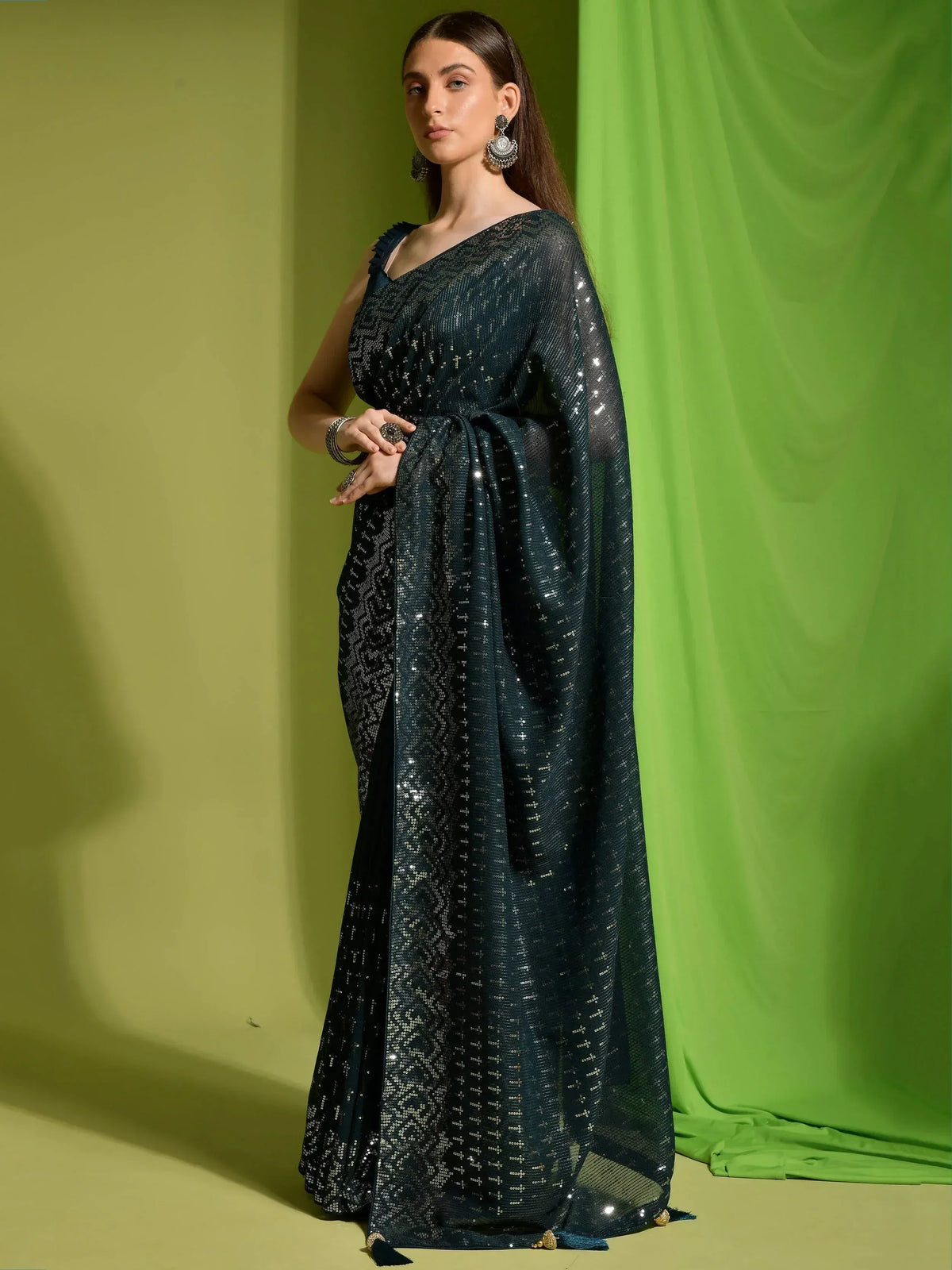 Elegant dark green sequined saree with one-shoulder blouse, perfect for Indian ethnic occasions