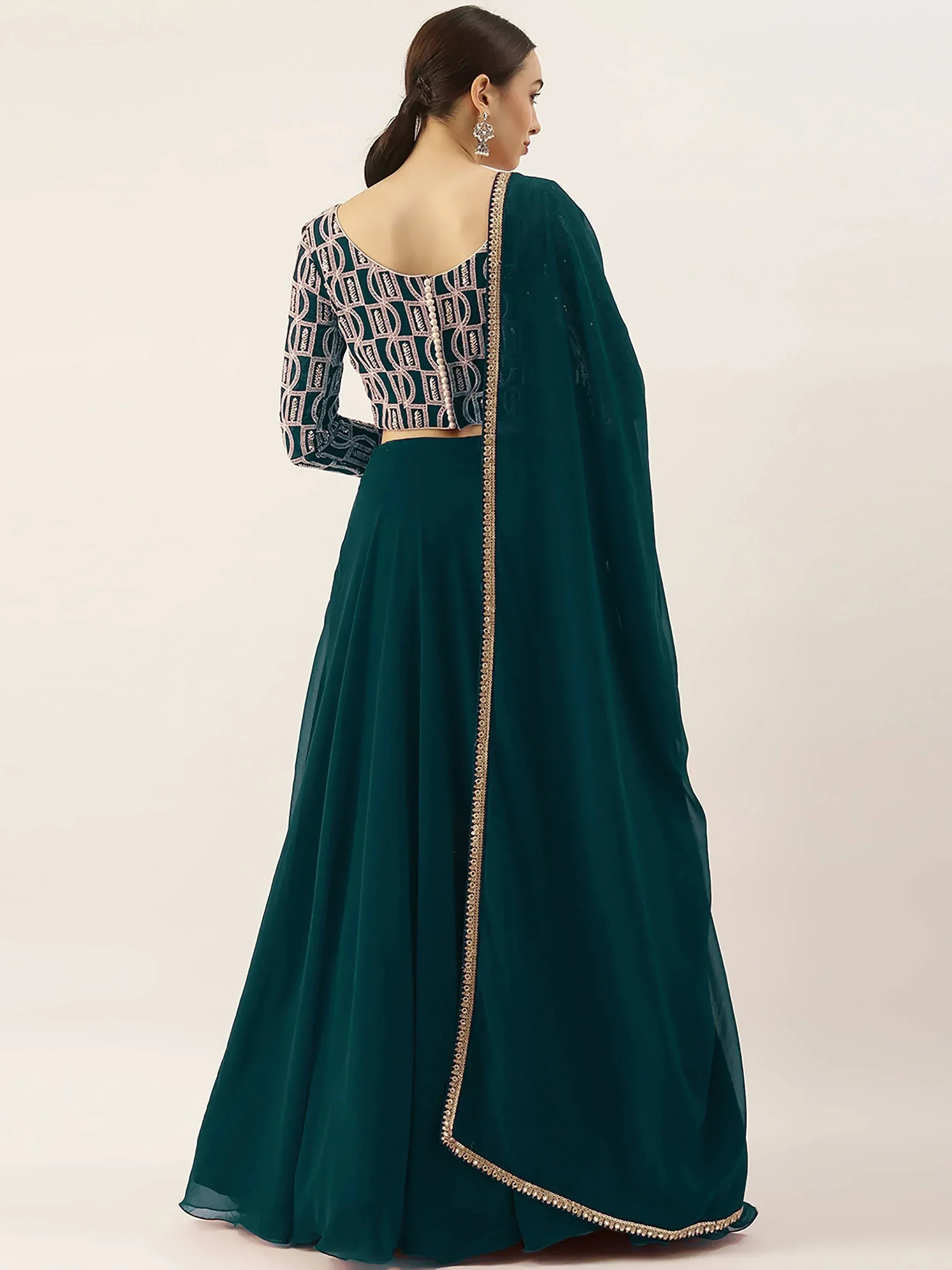 Emerald green designer lehenga choli with geometric embroidery and gold trim, perfect for Indian ethnic wear