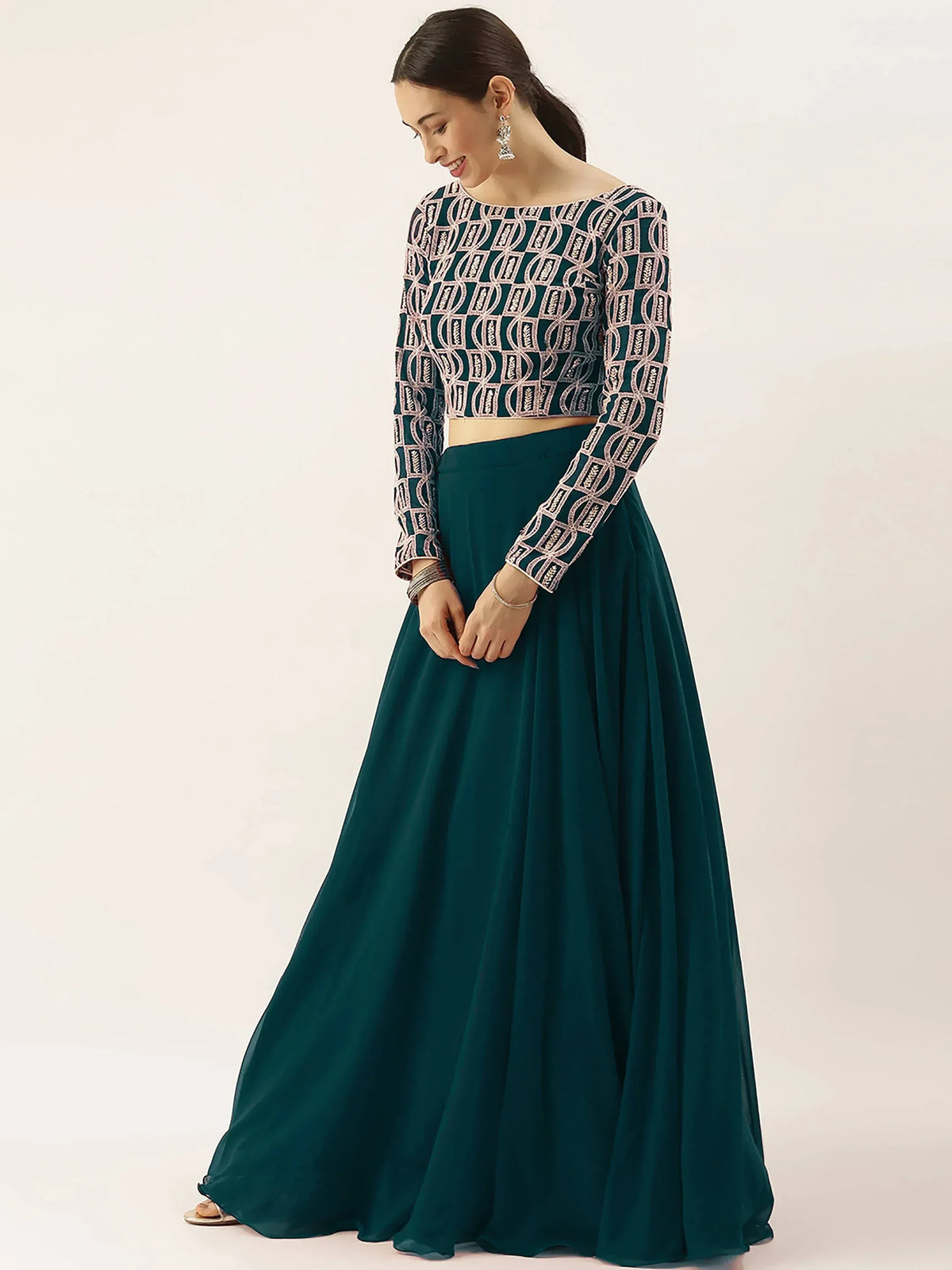 Emerald green ethnic lehenga with embroidered crop top, perfect for Indian weddings and festive occasions.