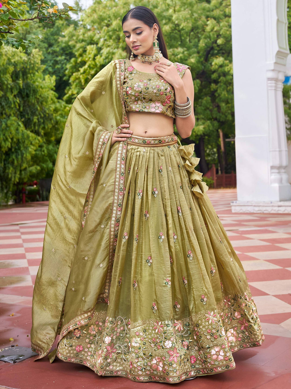 Olive green floral embroidered lehenga choli with ruffle detailing, perfect for Indian weddings and festive occasions.