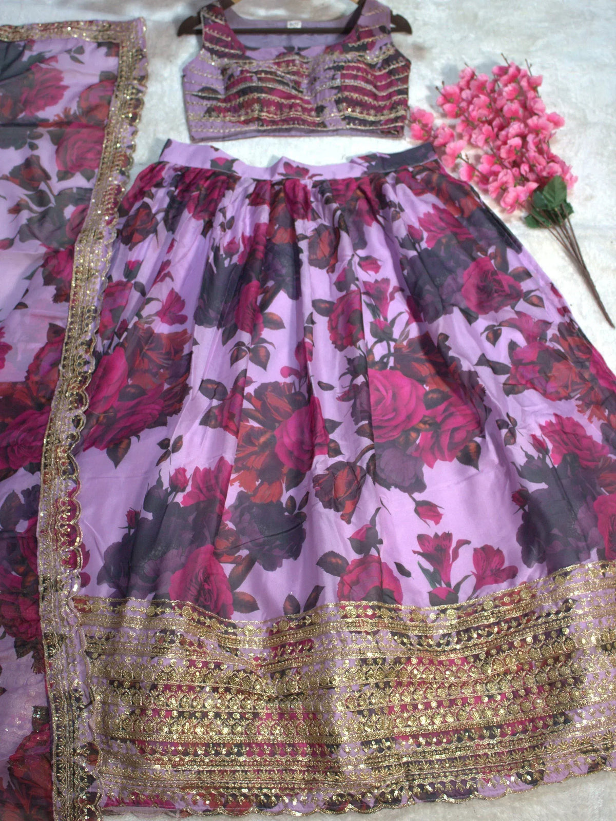 Purple floral lehenga choli with gold embroidery and matching dupatta, perfect for Indian ethnic wear.