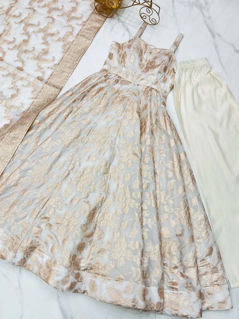 Elegant white and gold floral print ethnic gown with matching palazzo pants and dupatta, perfect for Indian occasions.
