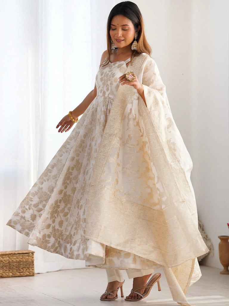 Elegant white and gold floral print ethnic gown with cape sleeves, perfect for Indian festive occasions.