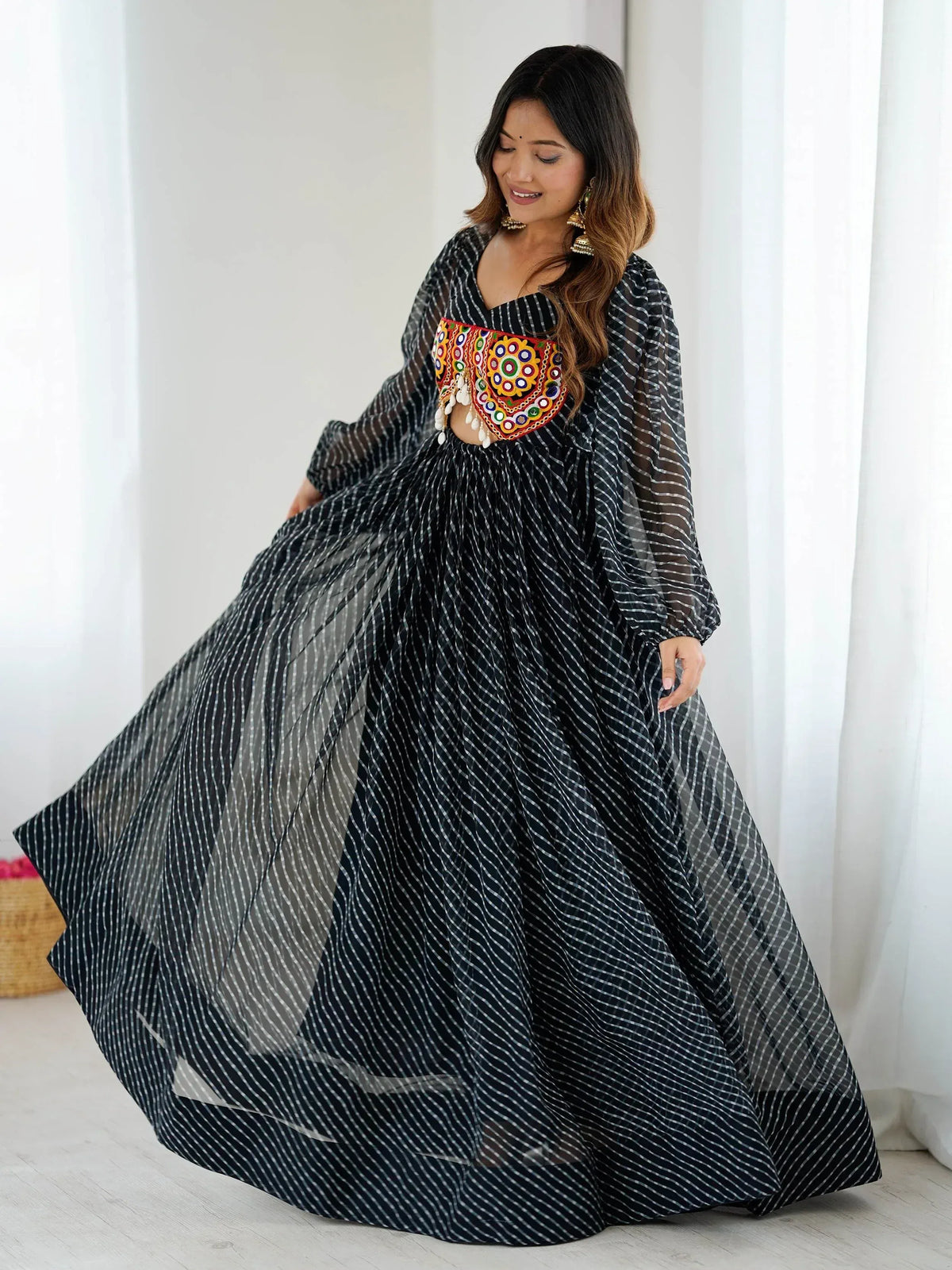 Black and white striped ethnic gown with colorful embroidered bodice, perfect for Indian occasions.