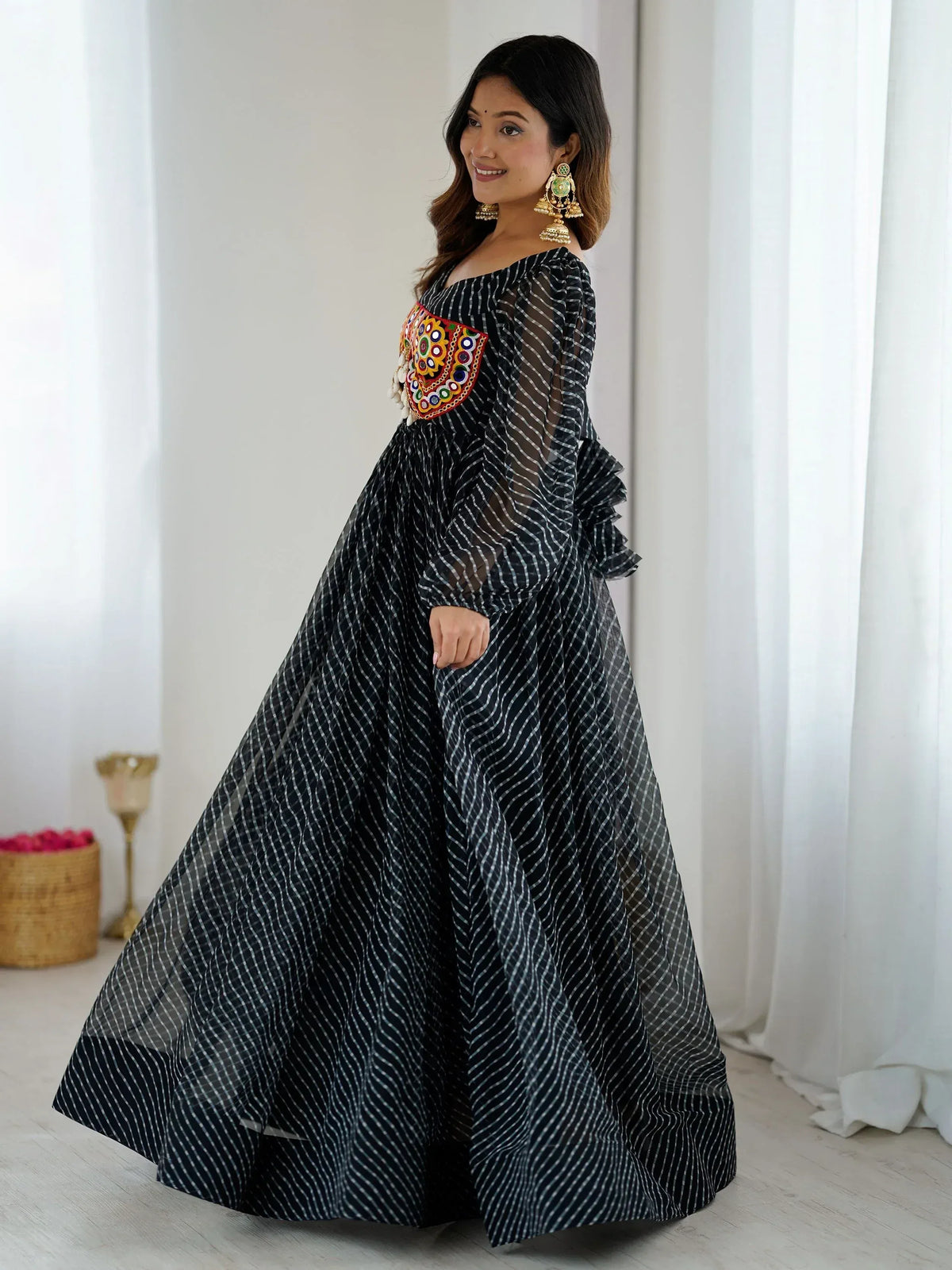 Black and white striped ethnic gown with colorful mirror work, off-shoulder design, and sheer sleeves