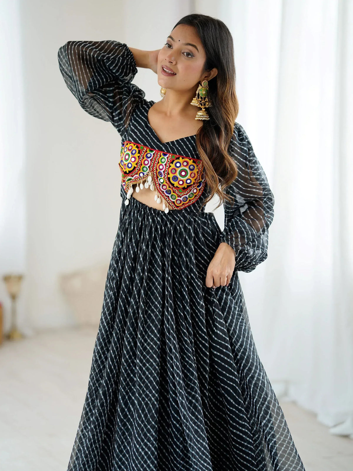 Black and white striped ethnic gown with colorful mirror work blouse, perfect for Indian festive occasions.