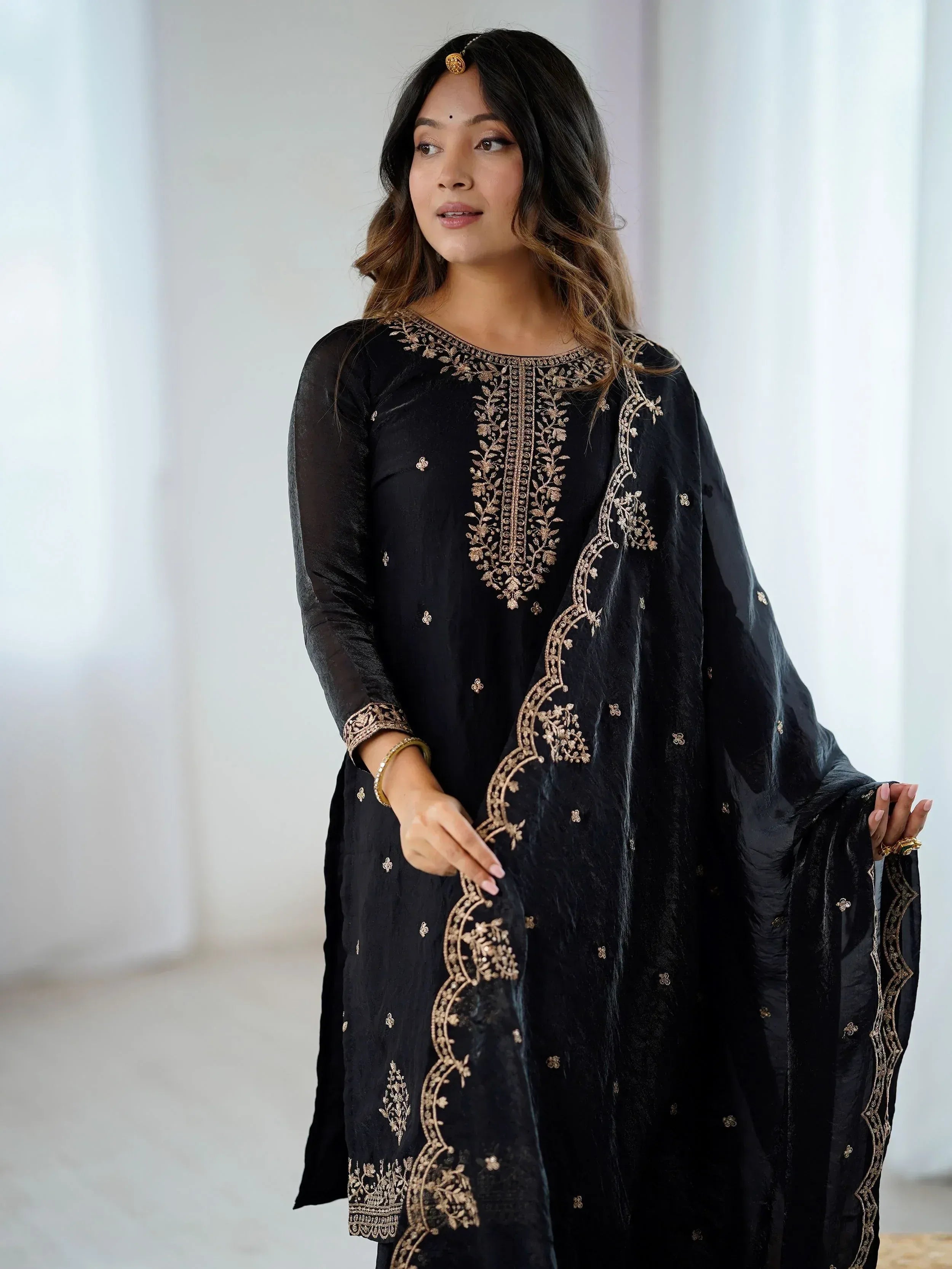 Black velvet ethnic gown with gold embroidery, perfect for Indian festive occasions and parties.
