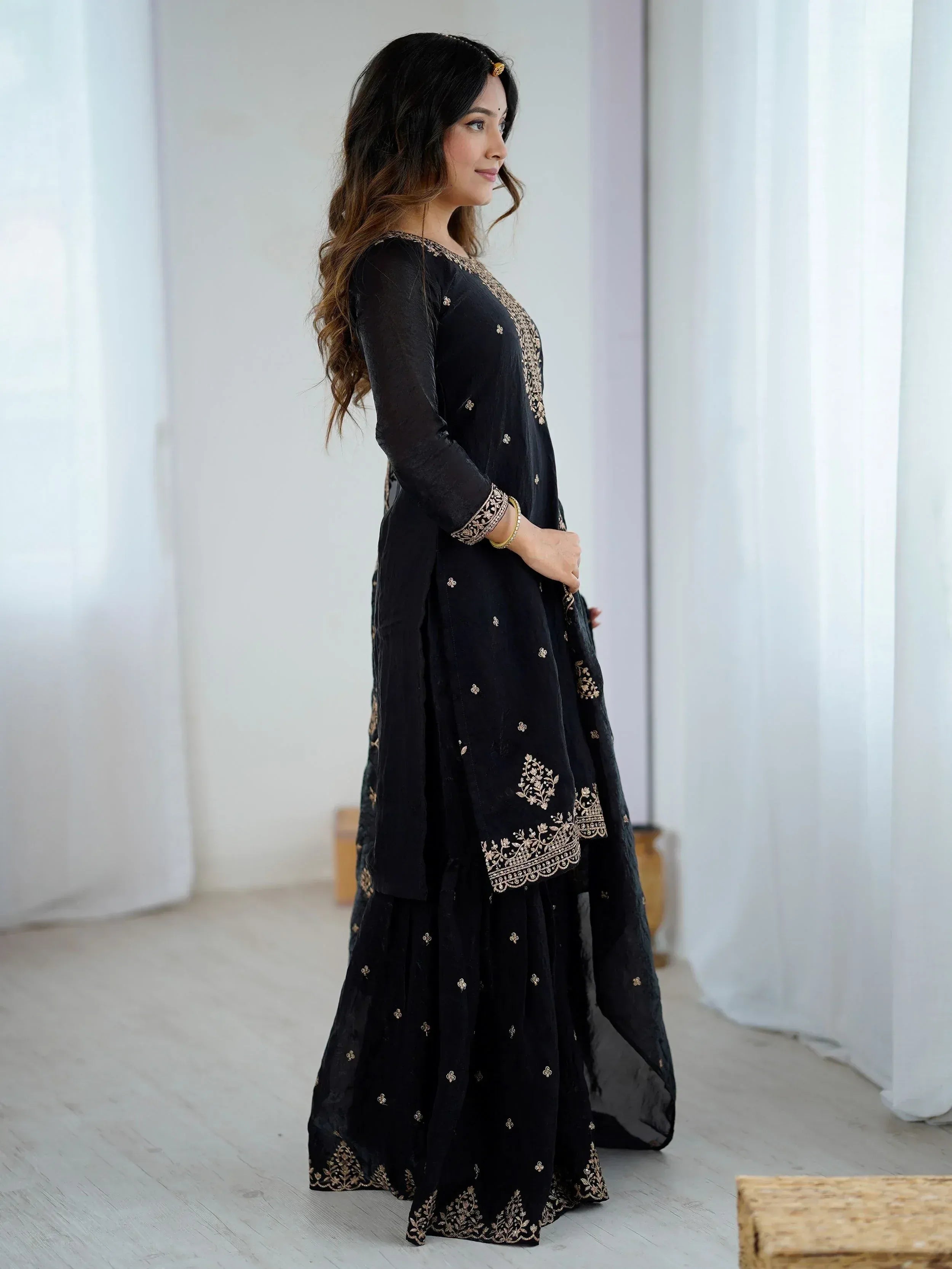 Black ethnic gown with gold embroidery, perfect for Indian occasions and festive wear.