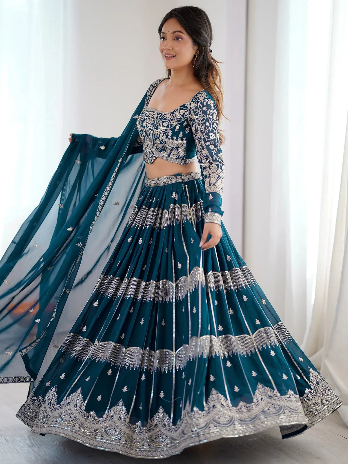 Teal designer lehenga choli with silver embroidery and dupatta, perfect for Indian ethnic wear occasions
