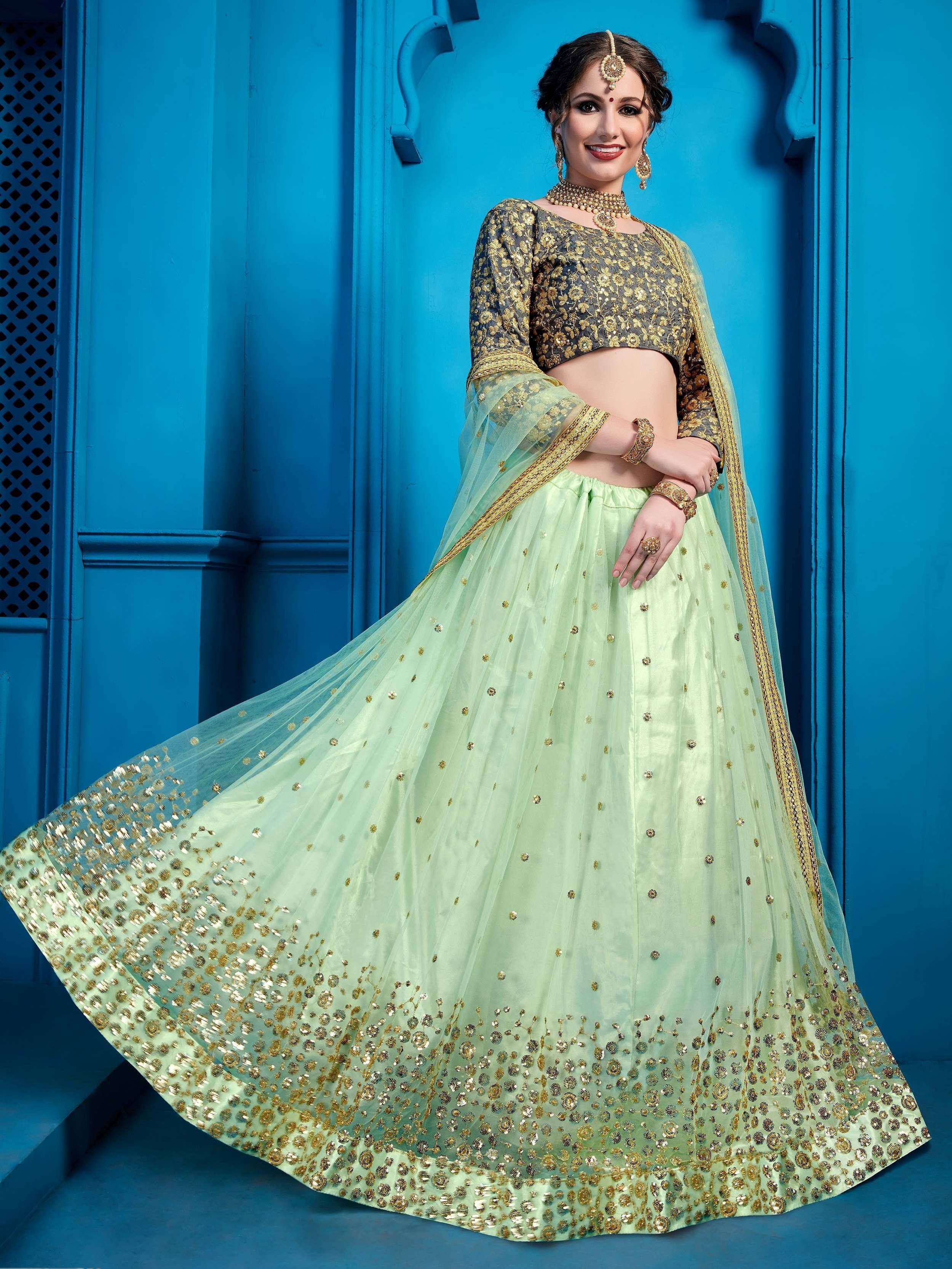 Mint green and gold embroidered lehenga choli with sheer dupatta, perfect for Indian weddings and festive occasions.