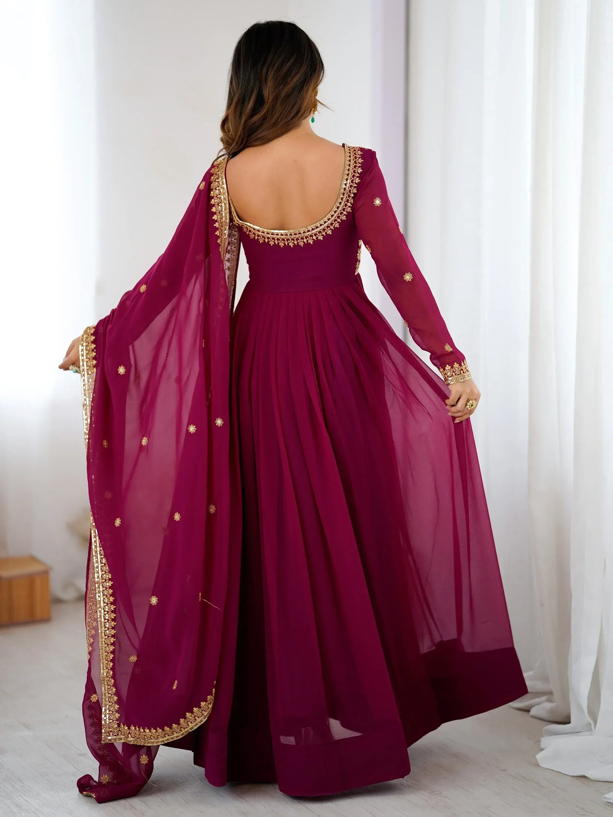 Burgundy ethnic gown with gold embroidery and sheer dupatta, back view