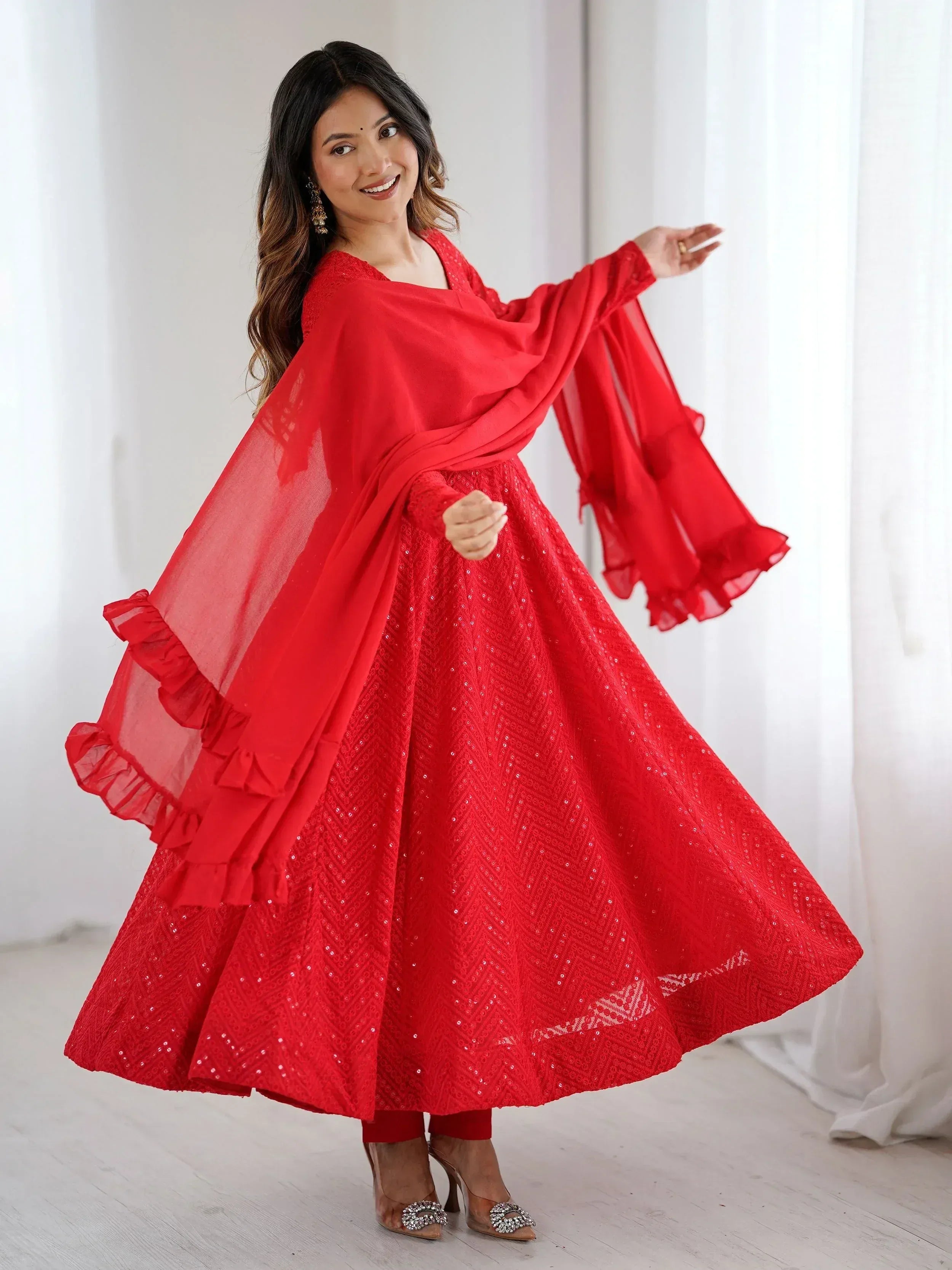 Red sequin ethnic gown with ruffled sleeves and dupatta, perfect for festive occasions