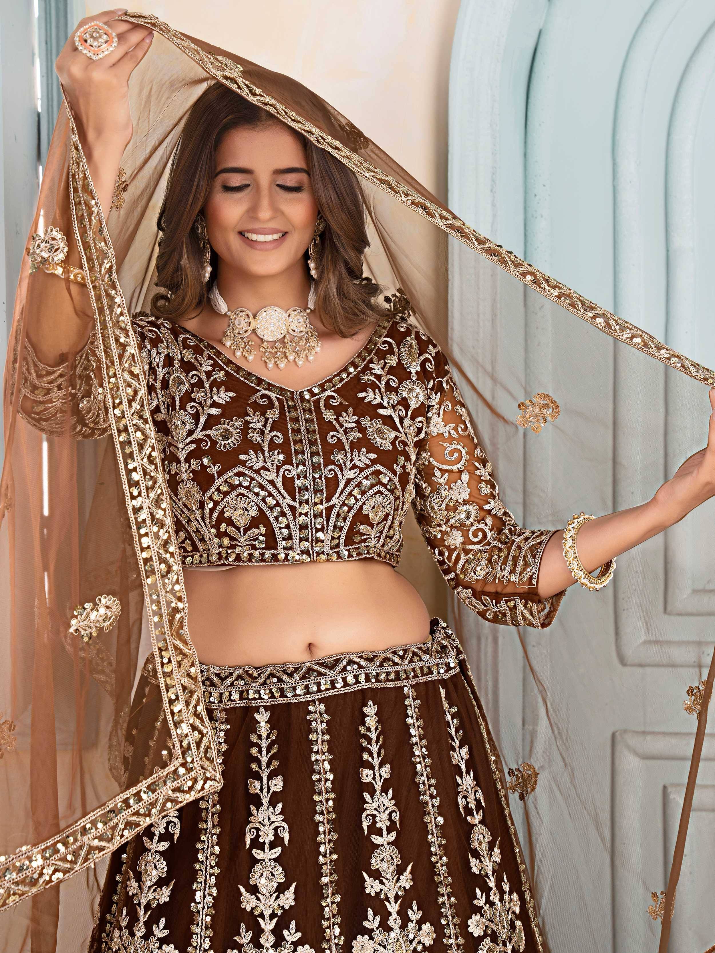 Elegant brown embroidered lehenga choli with gold detailing and matching dupatta, perfect for Indian ethnic wear.