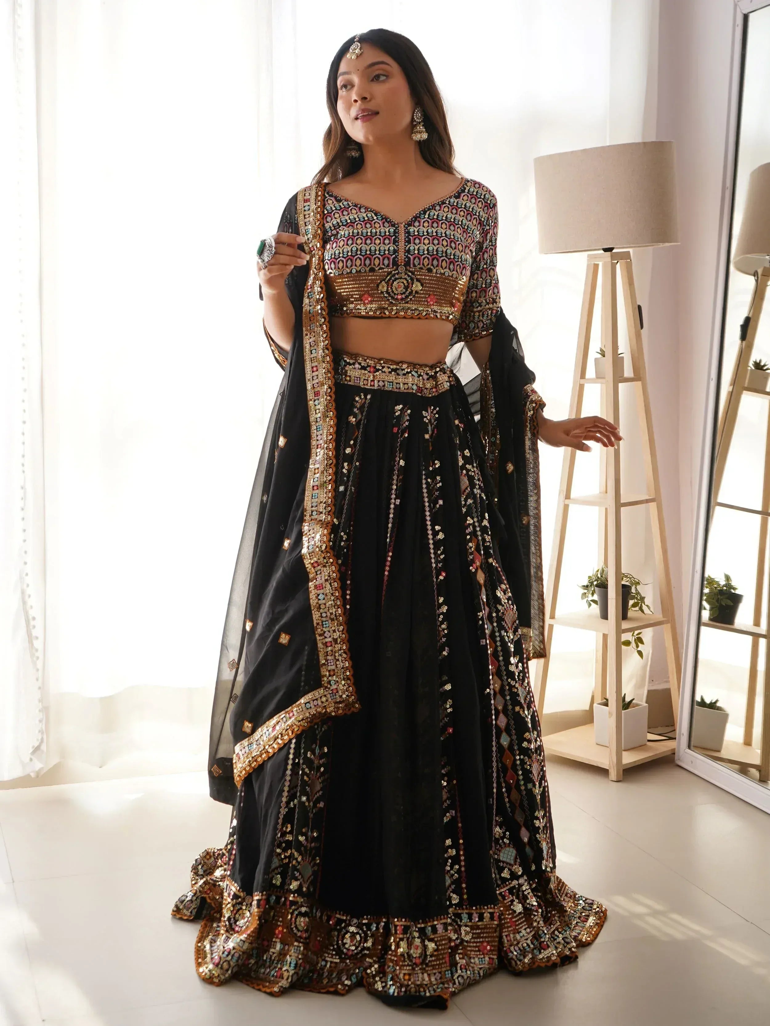 Black embroidered lehenga choli with mirror work, perfect for Indian ethnic wear and festive occasions.