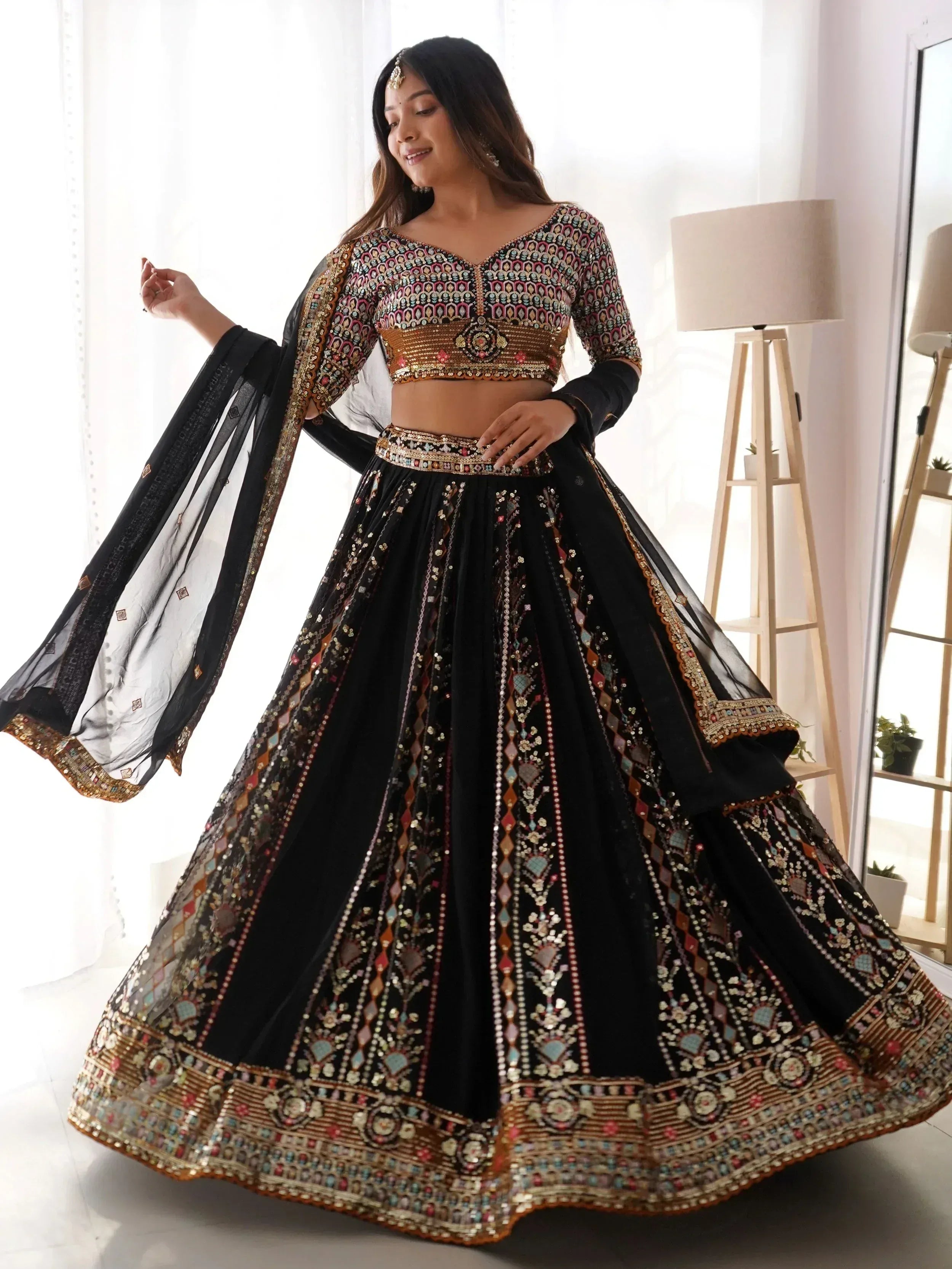 Black embroidered lehenga choli with colorful mirror work and sheer dupatta for Indian ethnic wear