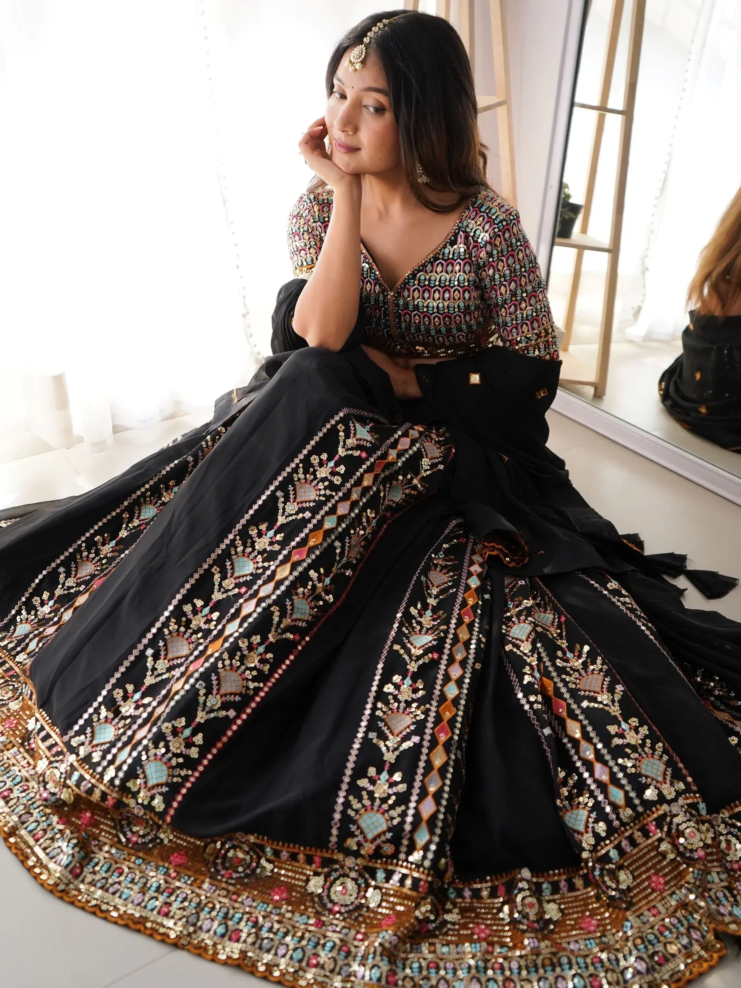 Black embroidered lehenga choli with colorful mirror work, perfect for Indian ethnic wear occasions