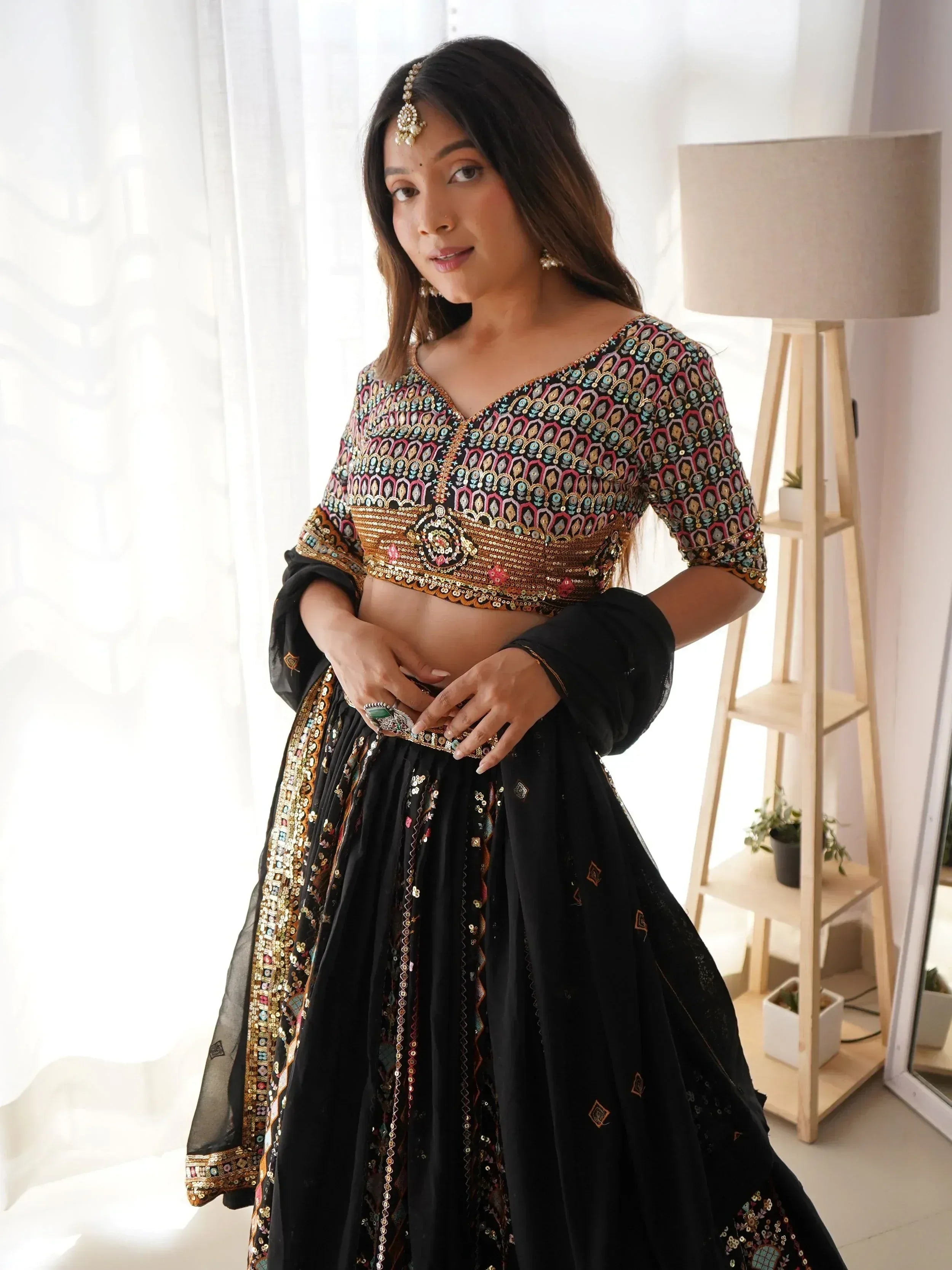 Black embroidered lehenga choli with colorful sequin work, perfect for Indian ethnic wear events.