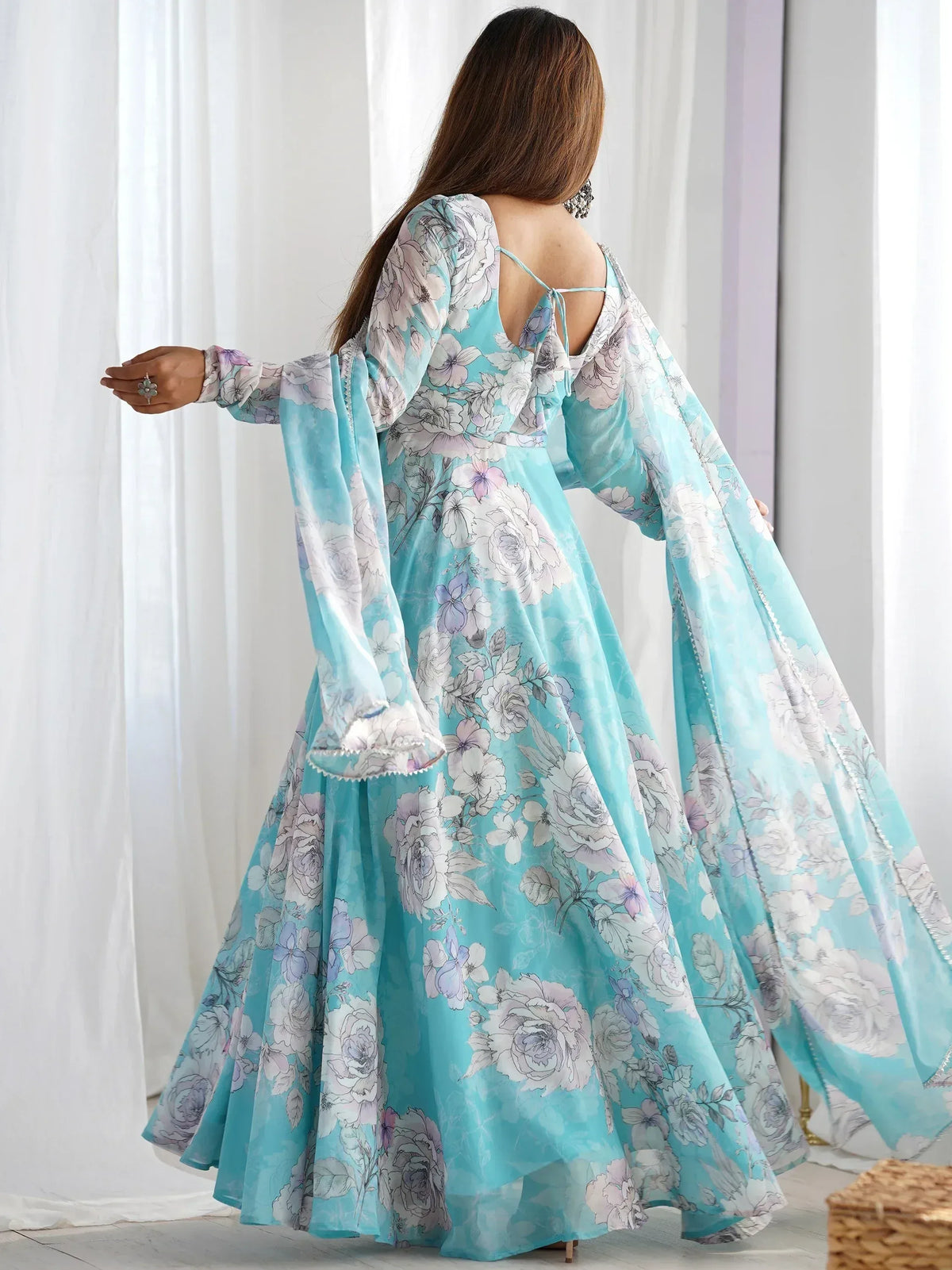 Turquoise floral print ethnic gown with flared sleeves and open back, perfect for Indian occasions
