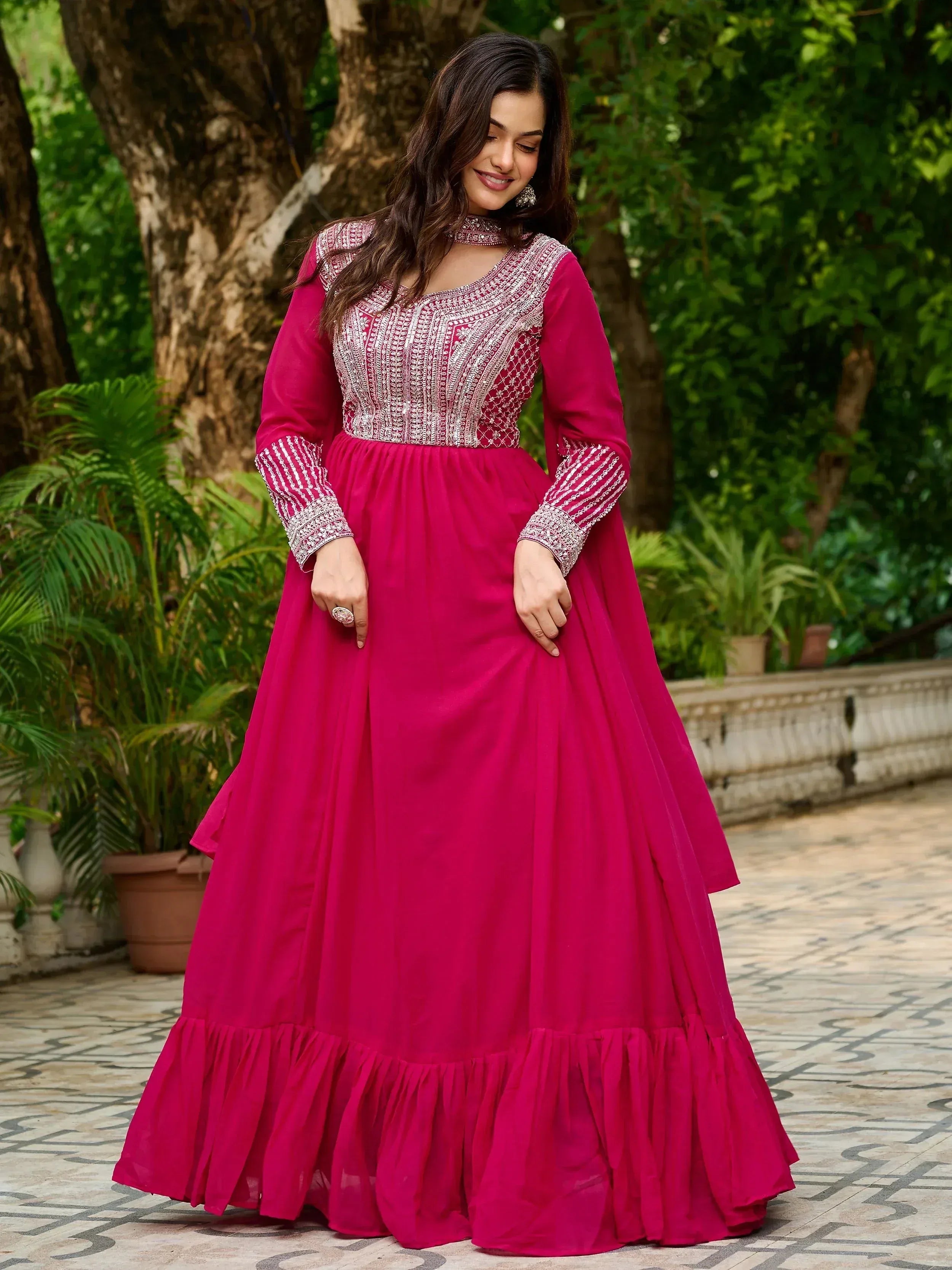 Fuchsia ethnic gown with silver embroidery, long sleeves, and ruffled hem for Indian occasions