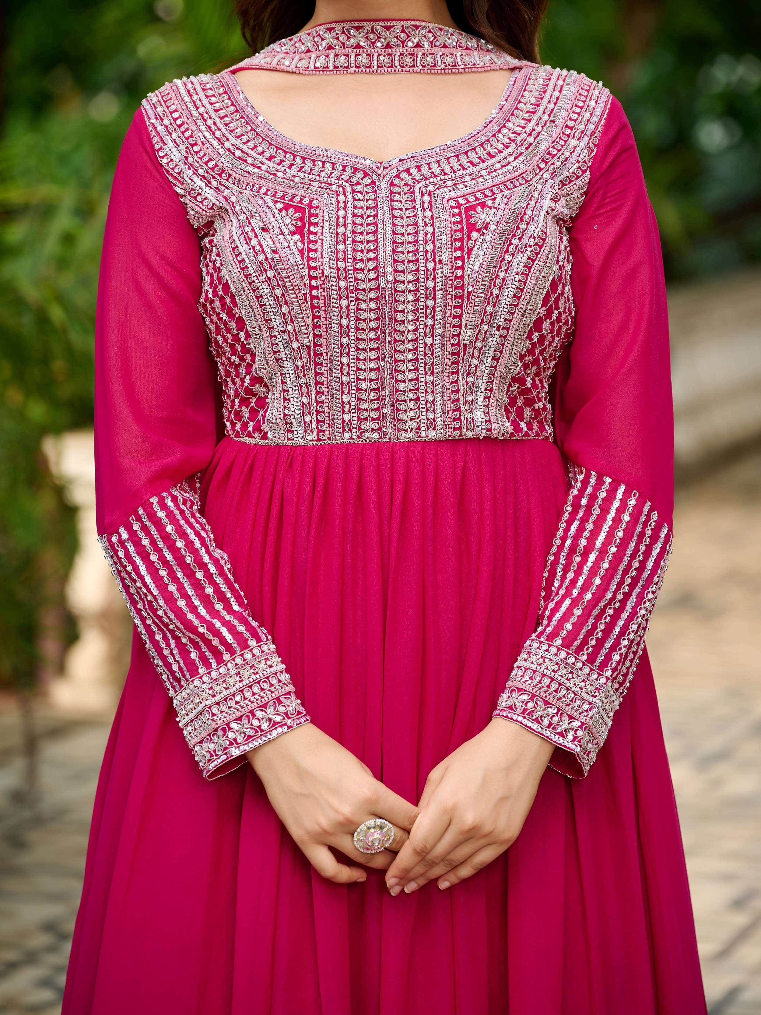 Pink ethnic gown with silver embroidery, pleated skirt, and detailed neckline for Indian wear
