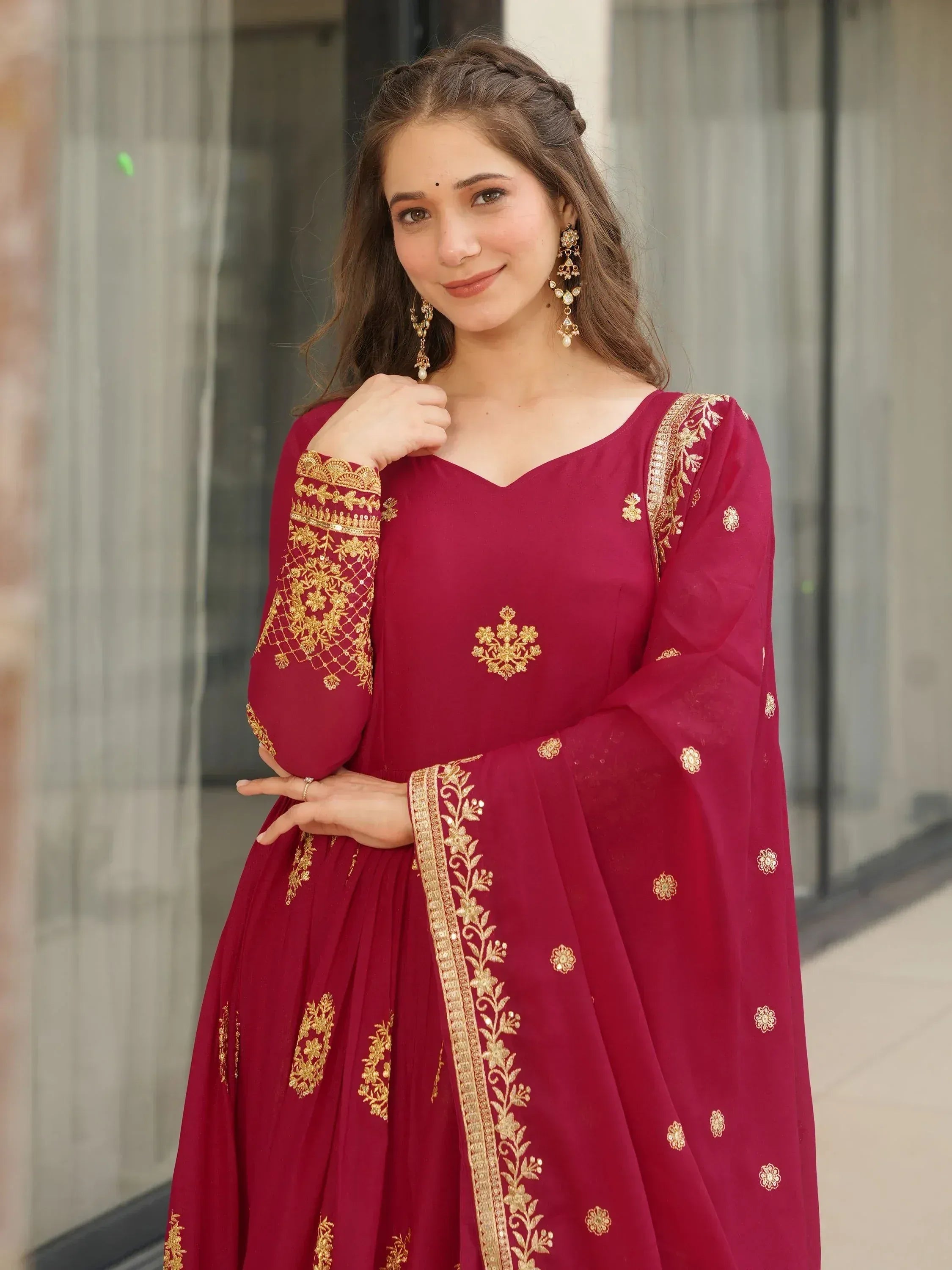 Maroon ethnic gown with gold embroidery, perfect for Indian occasions and festive wear