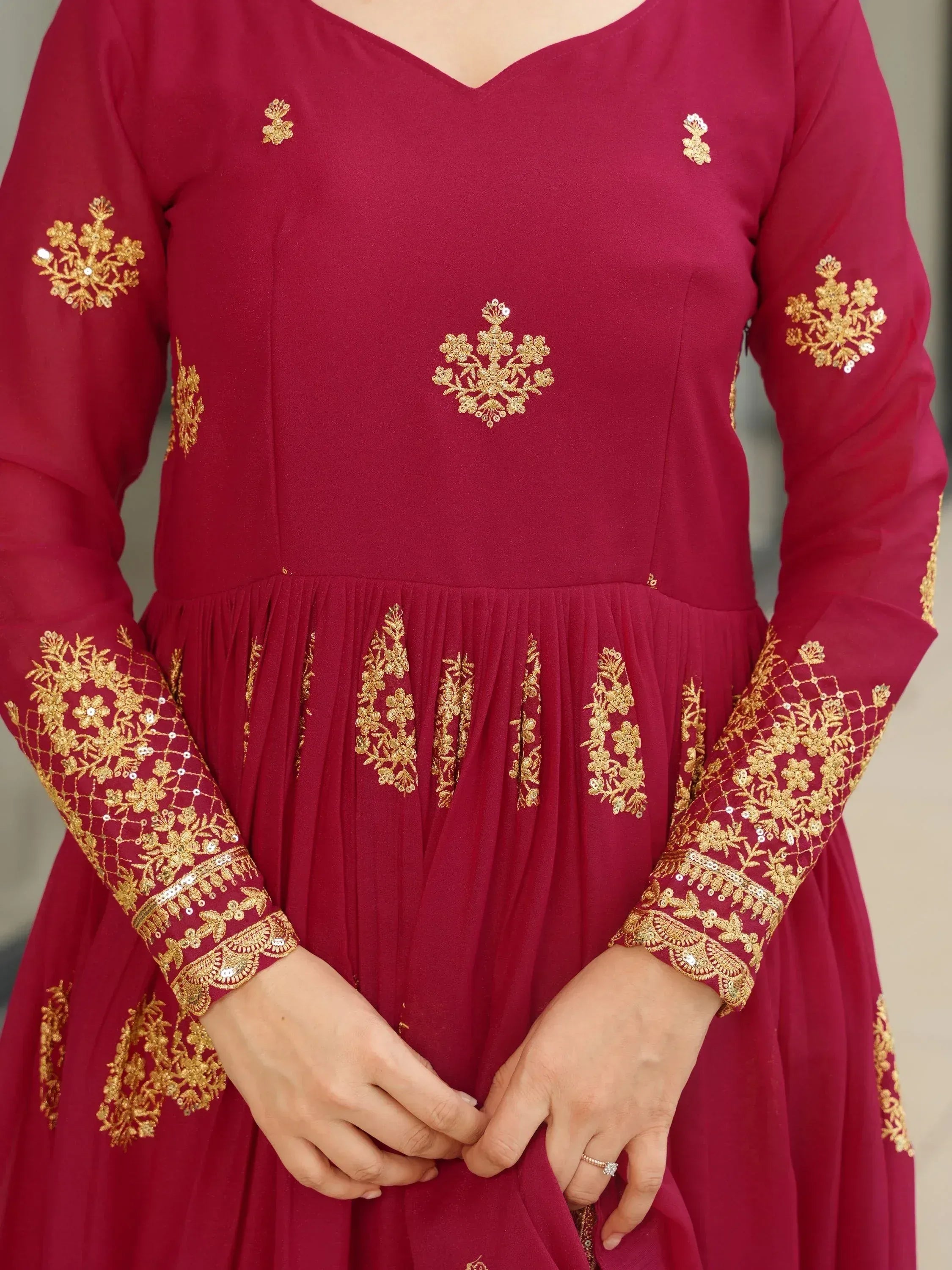 Maroon ethnic gown with gold floral embroidery and sequins, perfect for Indian occasions