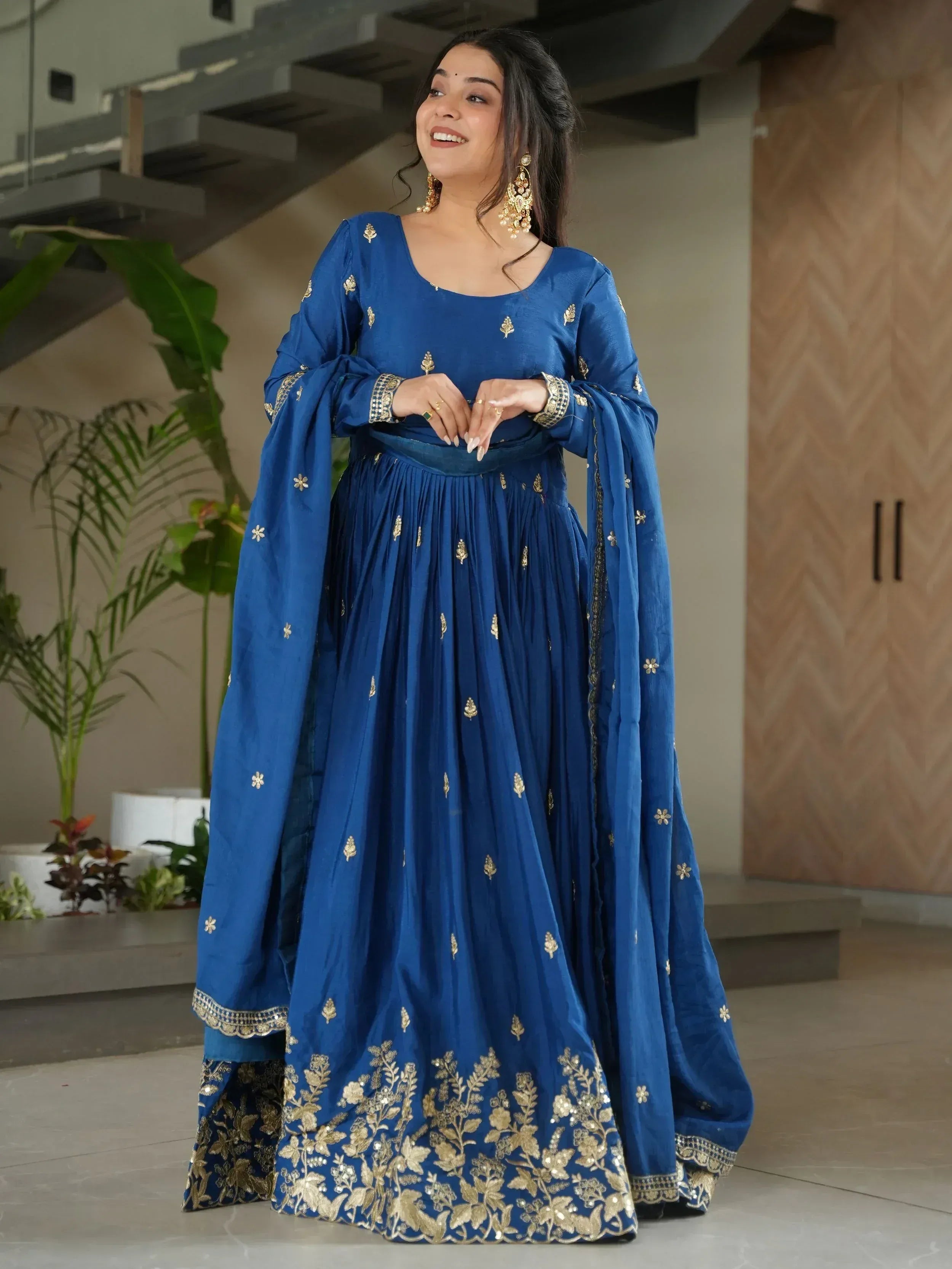 Blue ethnic anarkali suit with gold embroidery, perfect for Indian weddings and festive occasions.