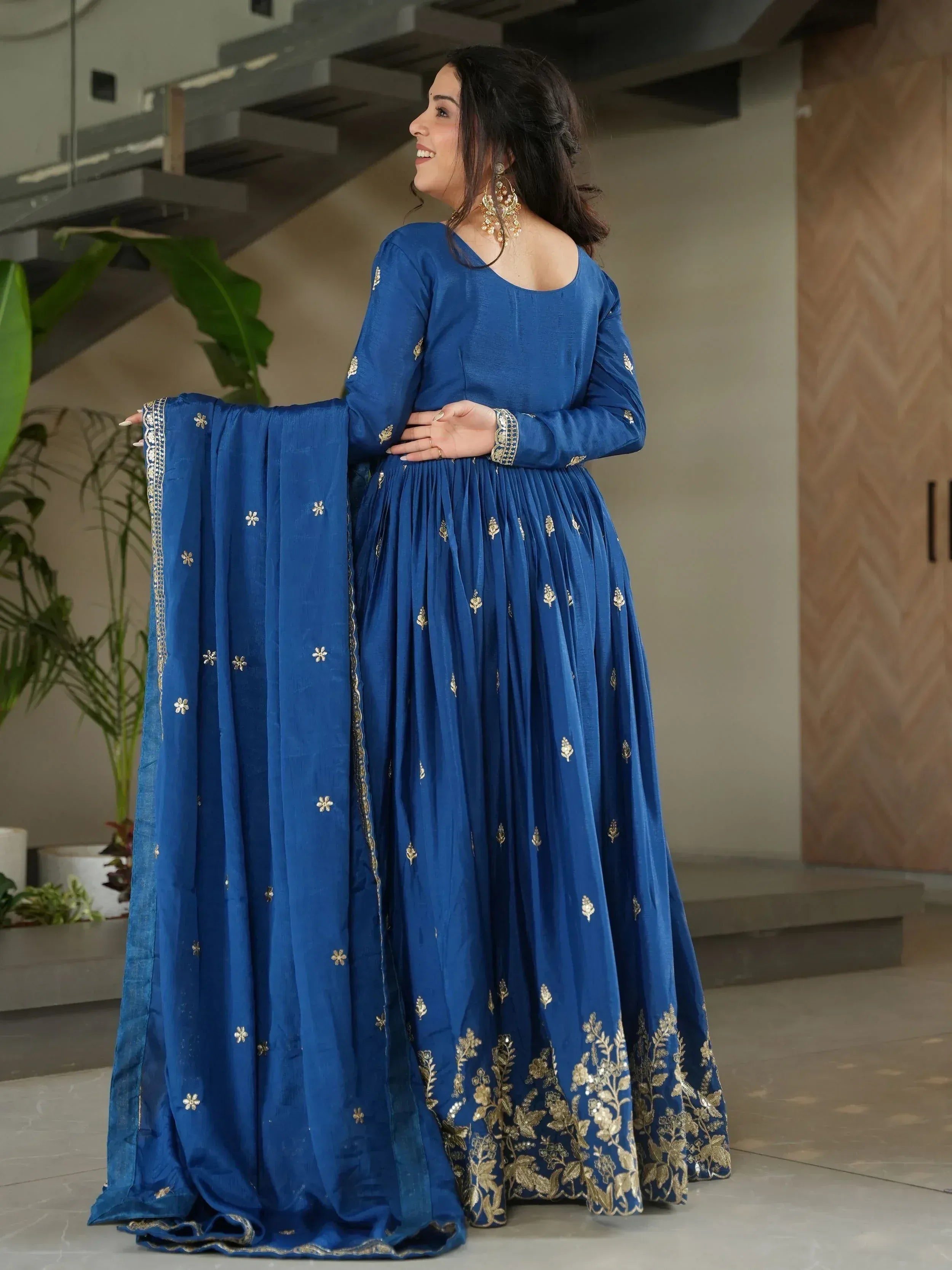 Royal blue ethnic anarkali with gold embroidery and matching dupatta, perfect for Indian weddings or festive occasions.