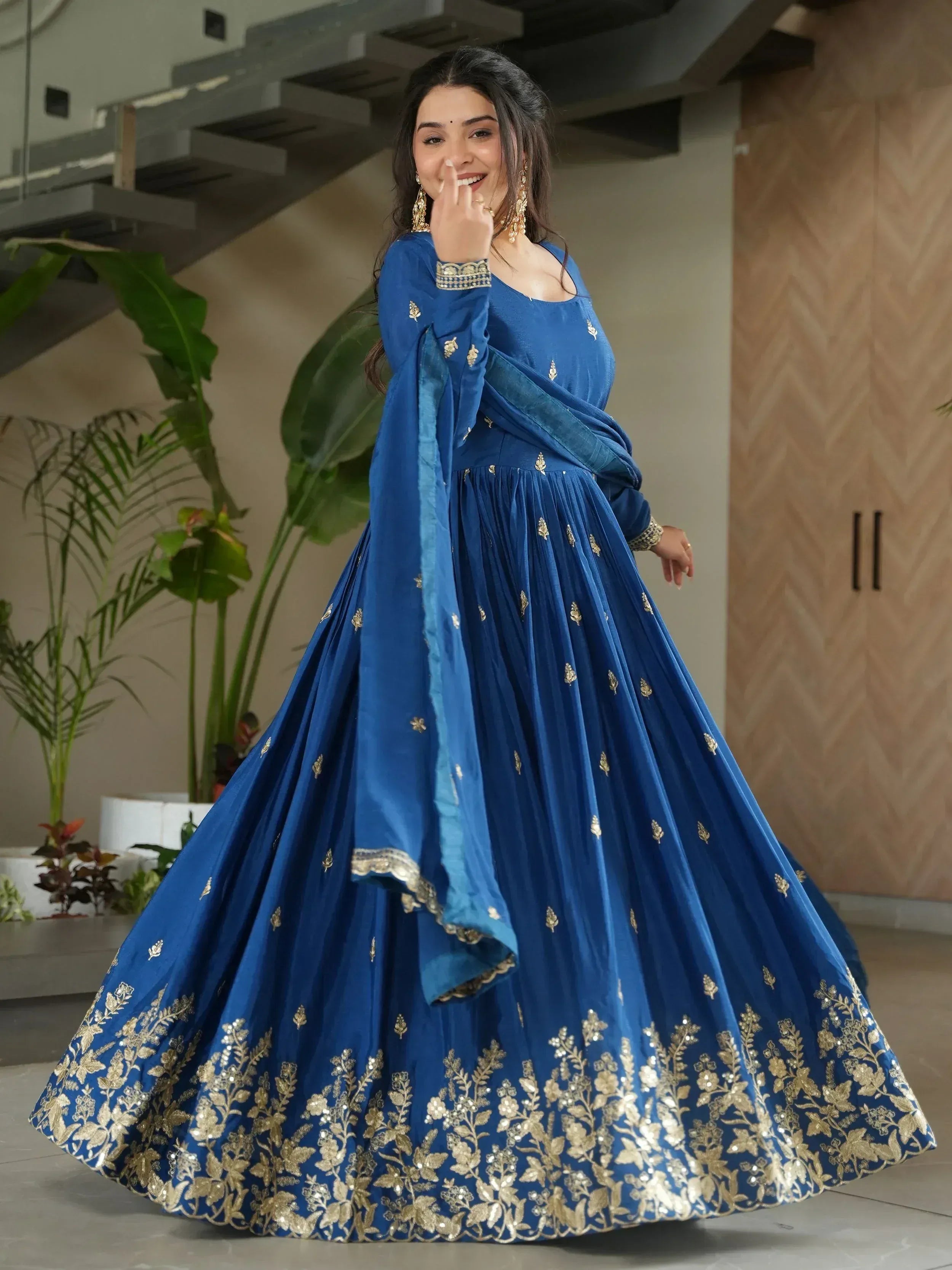 Blue designer lehenga choli with gold embroidery, perfect for Indian ethnic wear and festive occasions.