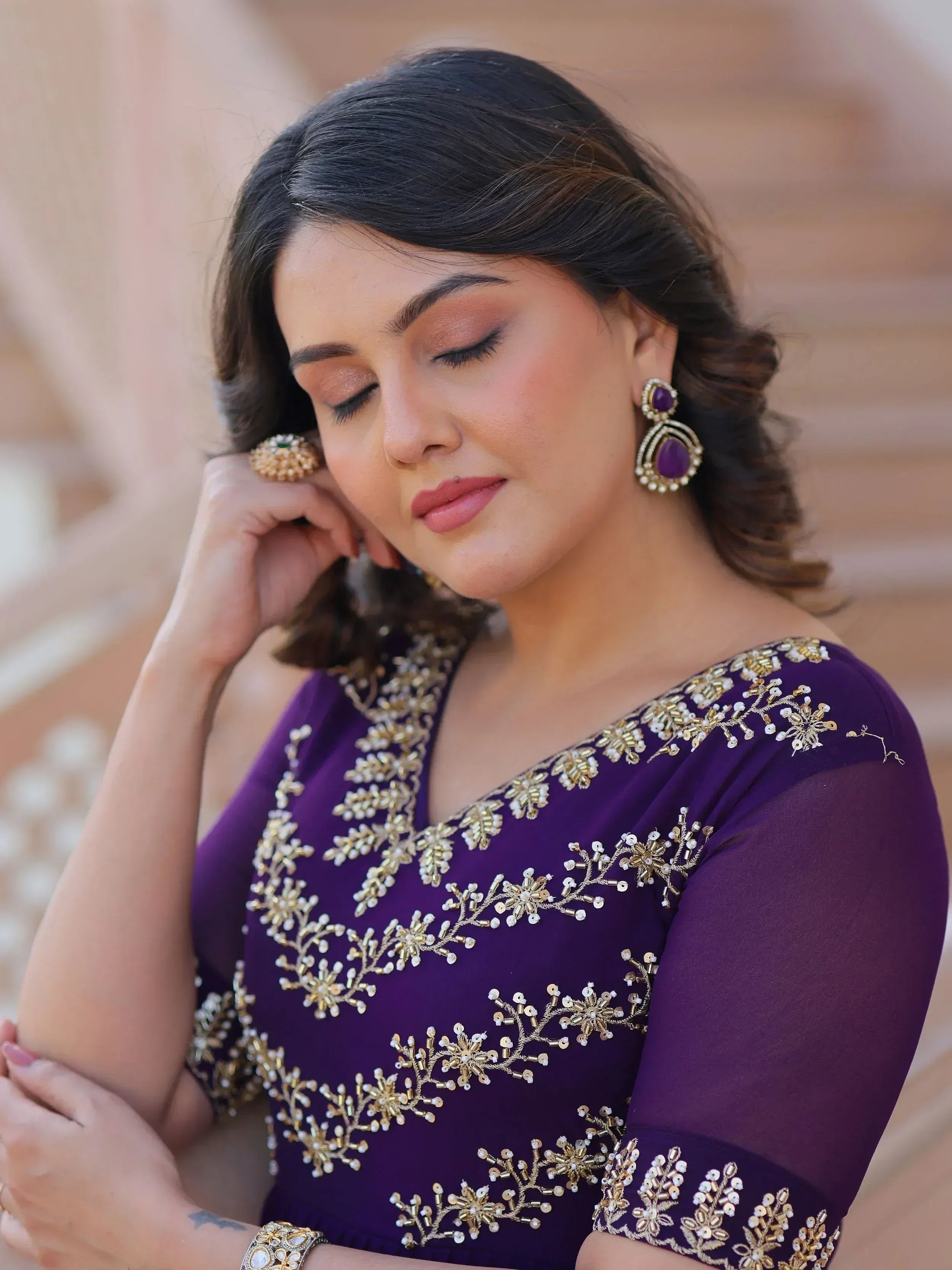 Purple ethnic gown with gold floral embroidery, perfect for Indian weddings or festive occasions.