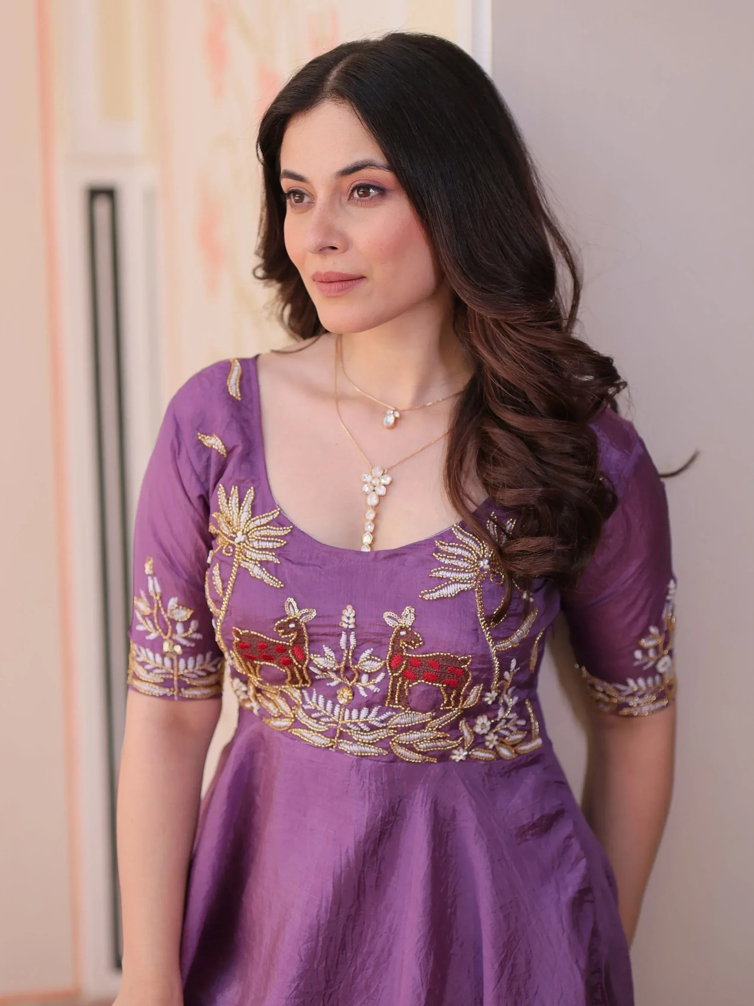Purple ethnic gown with deer and floral embroidery, perfect for Indian occasions