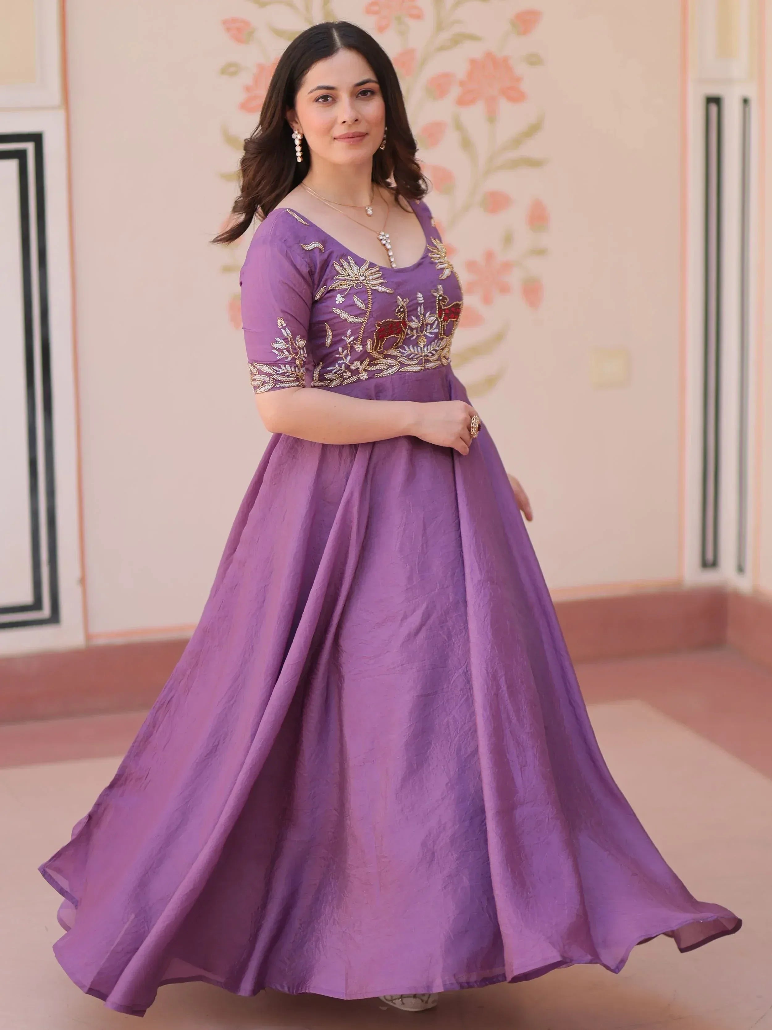 Purple ethnic gown with gold embroidery, floral and deer motifs, perfect for Indian festive occasions